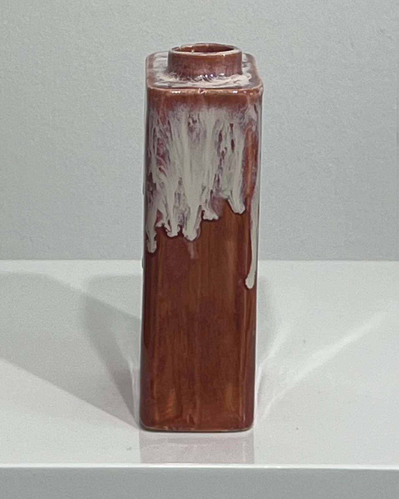 Side profile of ceramic carton showing the handmade form and dripping Light Flux glaze