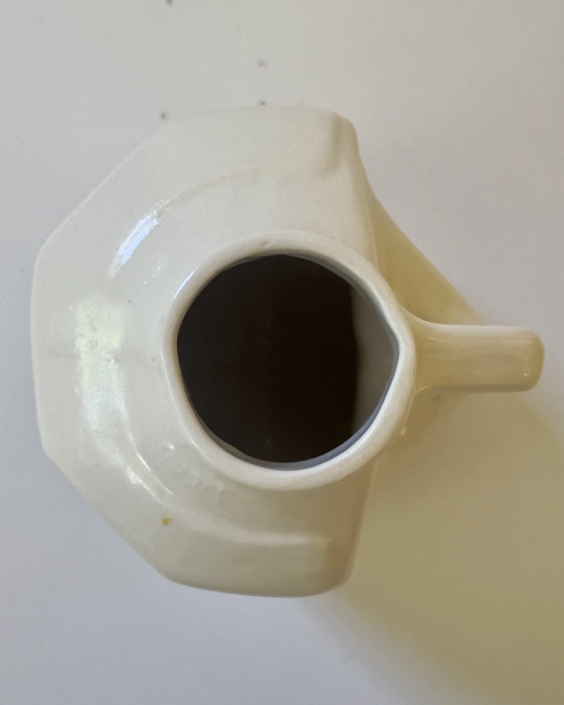 Top view of white ceramic jug vessel with narrow opening