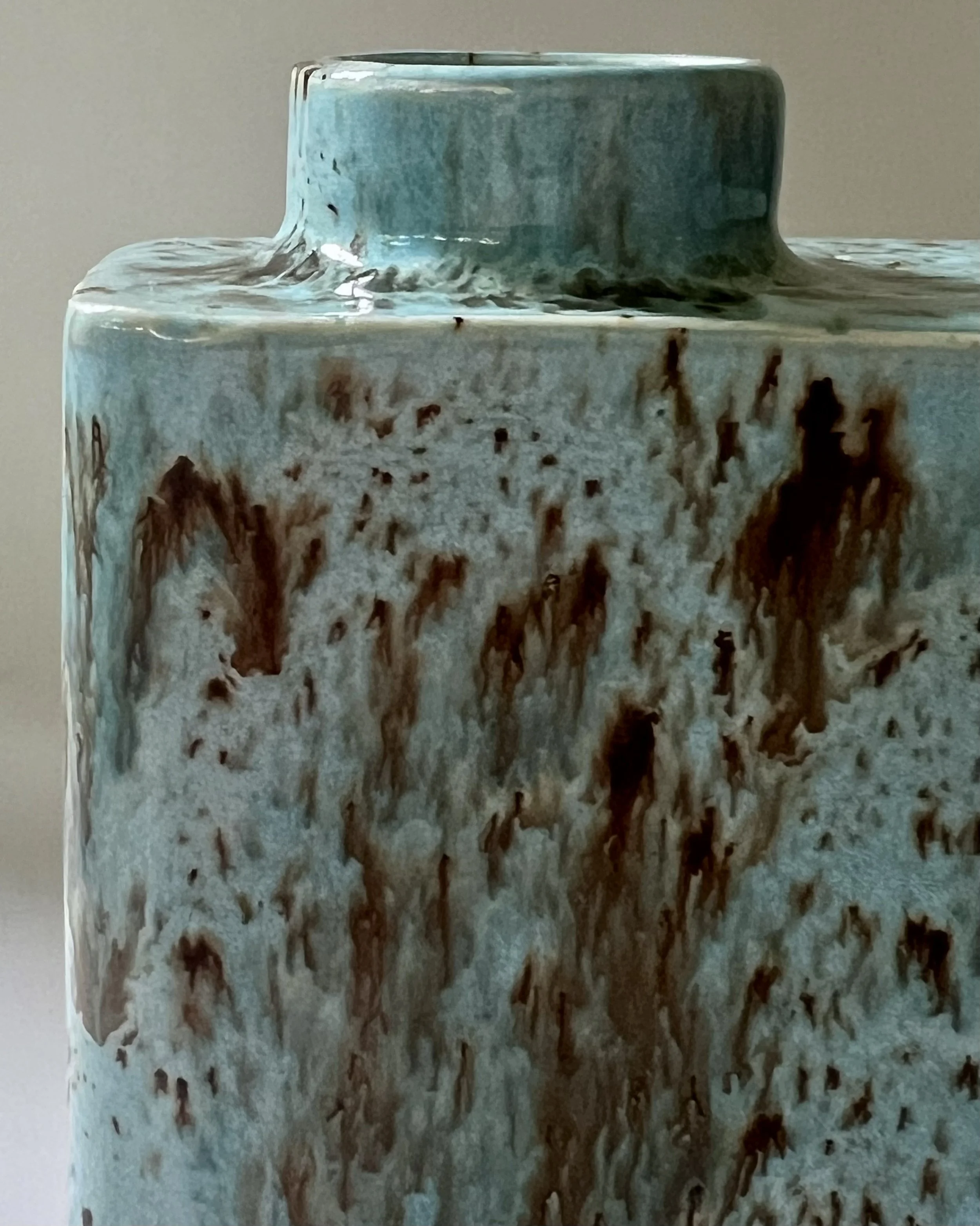 Close-up detail of Cenote glaze showing turquoise blue crystalline textures and flowing brown accents.