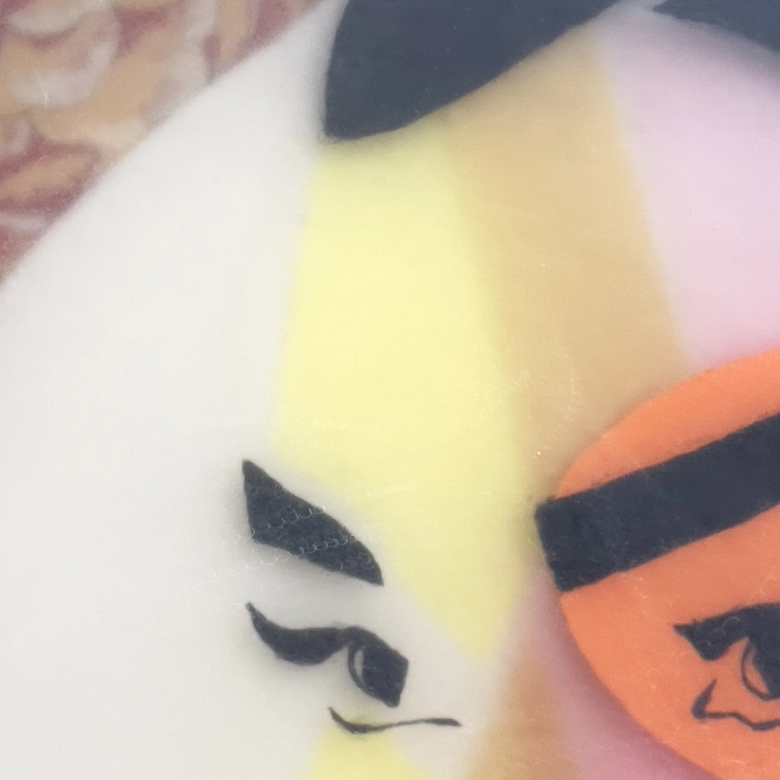 Close-up of Adeline showing overlapping geometric facial elements, expressive eyes, and layered resin