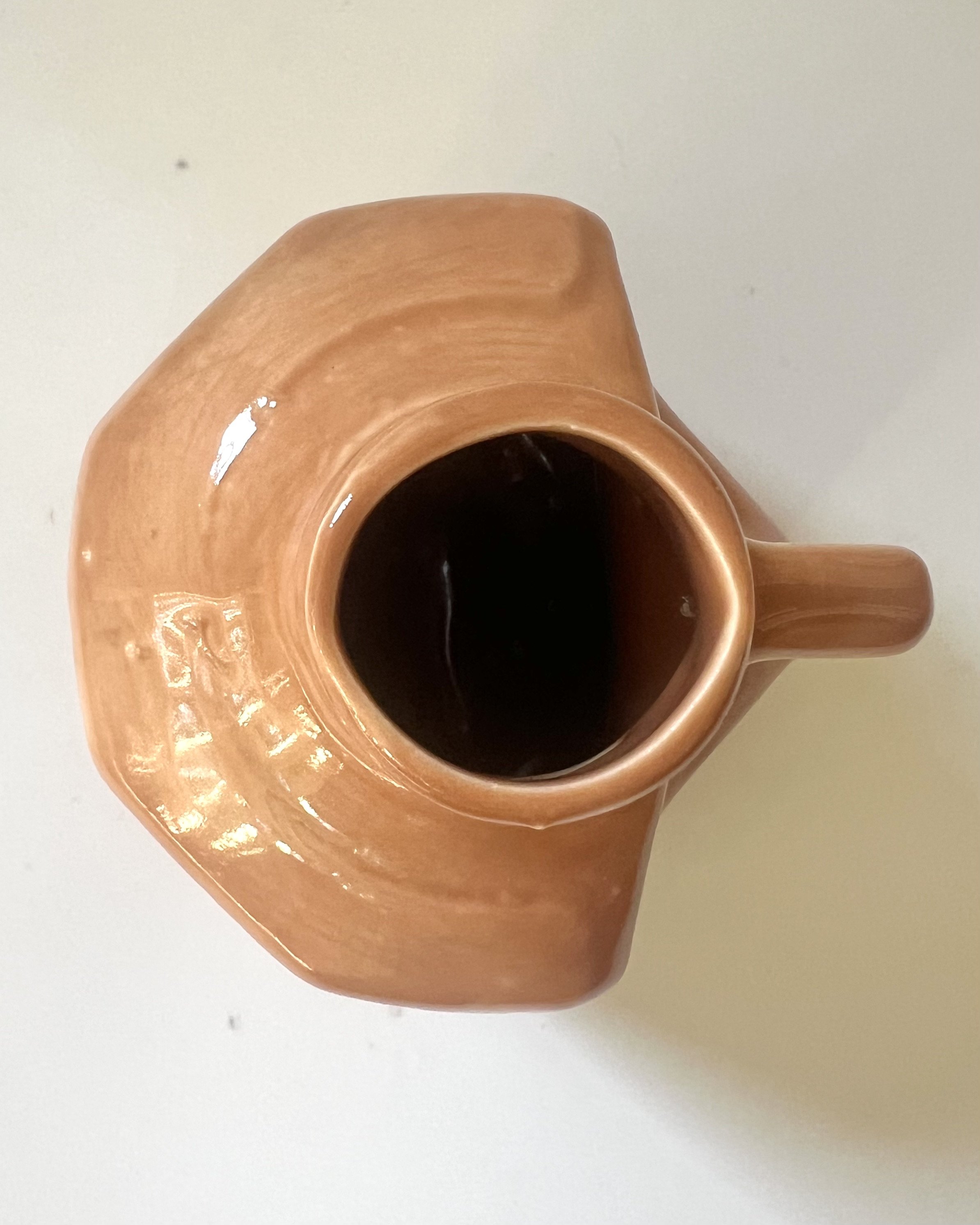 Top view of a porcelain milk jug vase showing the vessel opening and Sandalwood glaze.