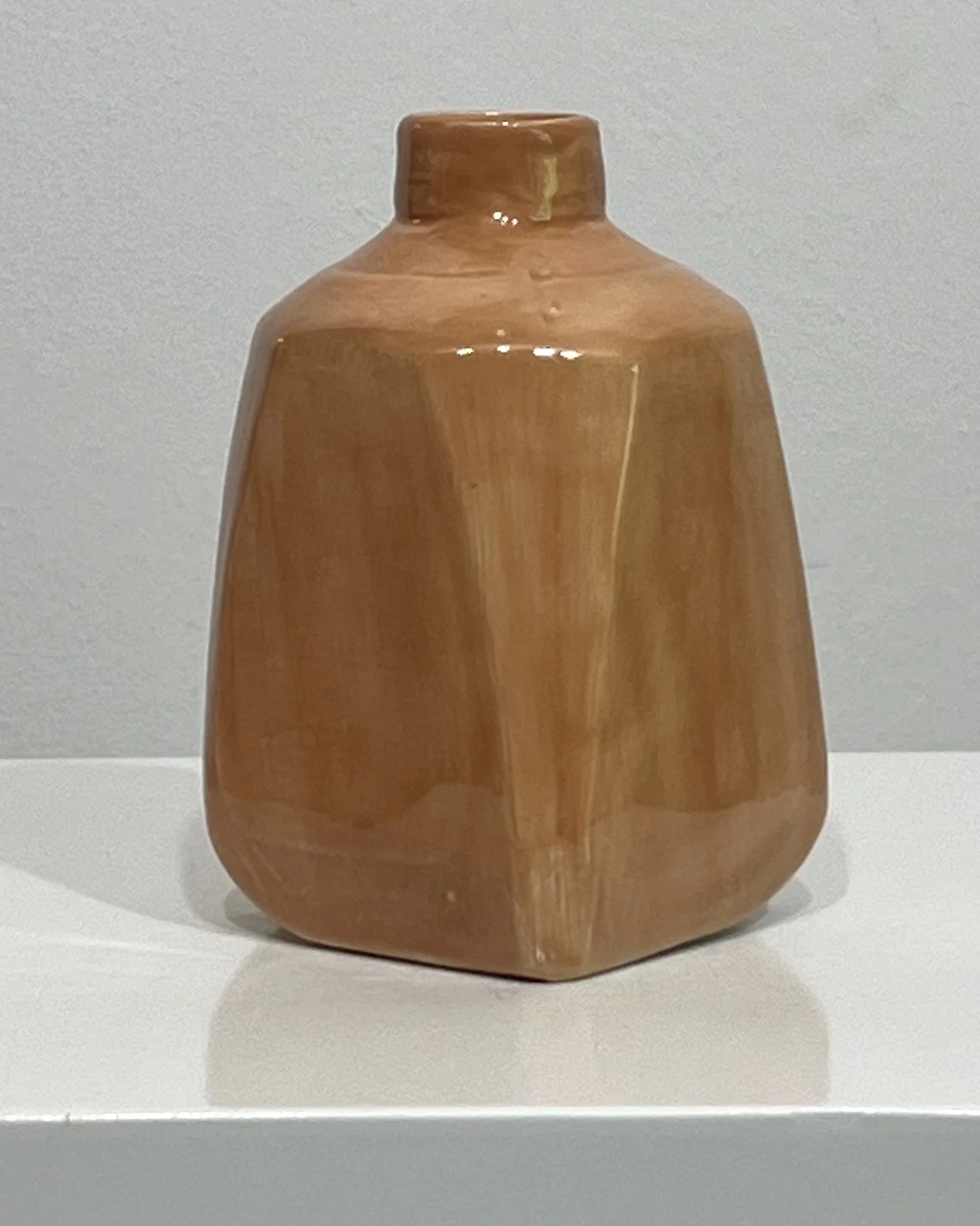 Porcelain milk jug vase viewed from the opposite side, highlighting the geometric form and soft glaze variation.