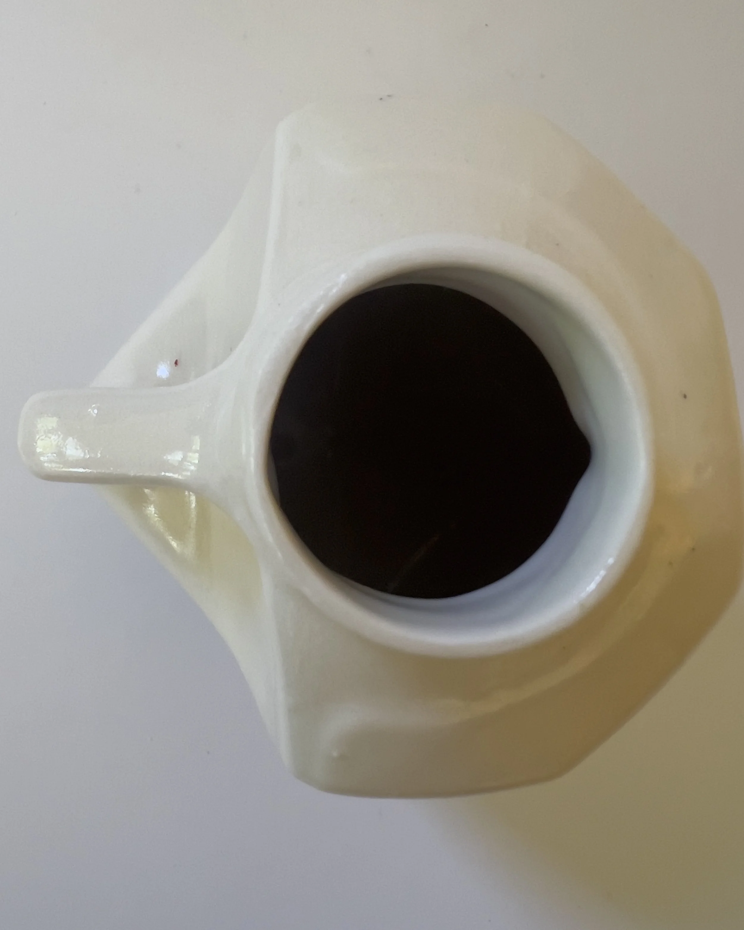 Top opening detail of sculptural ceramic milk jug