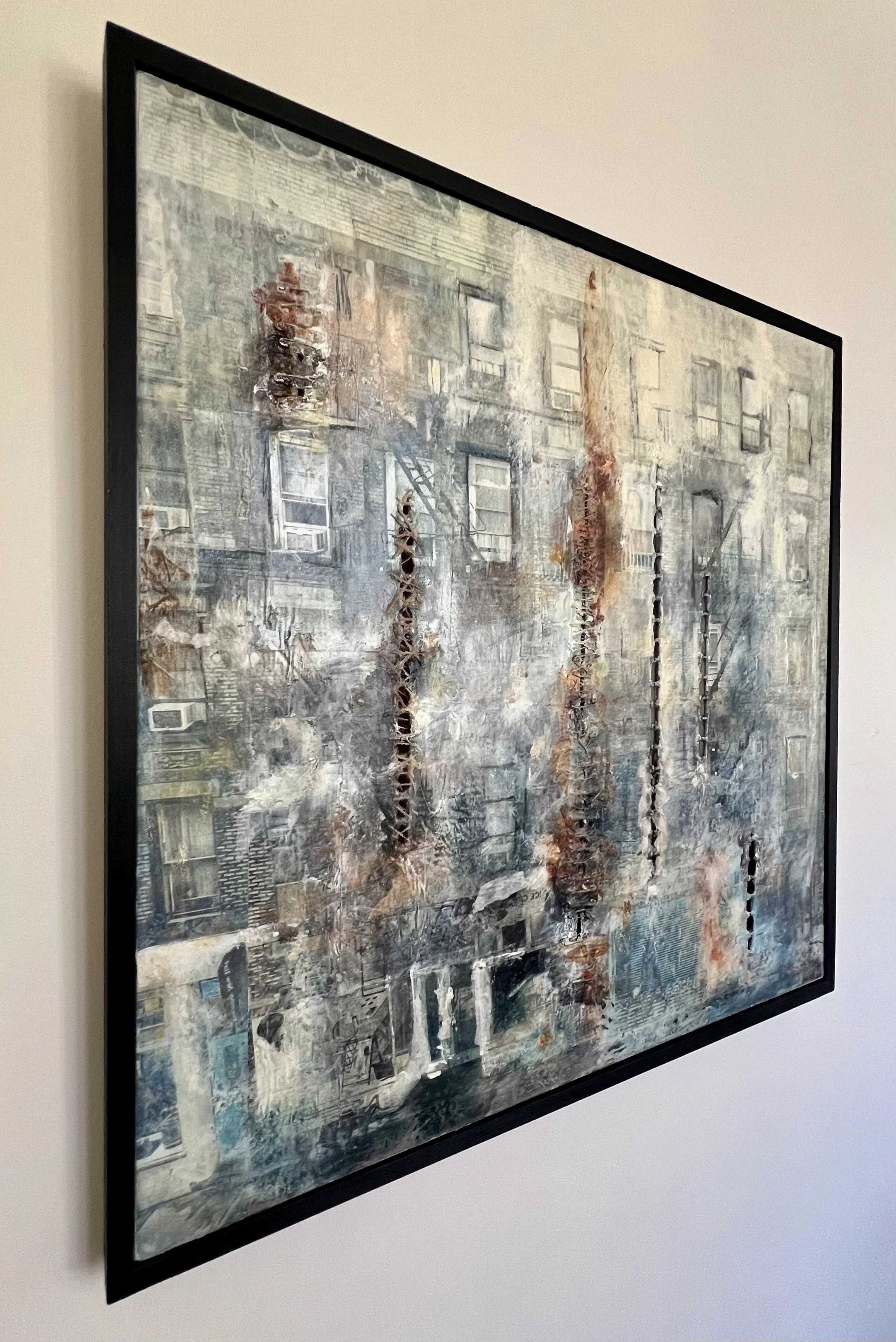Angled view of Indigo, an original framed 36 by 36 inch cold wax and mixed media painting by Alissa Van Atta, showing the artwork's textured surface and frame.