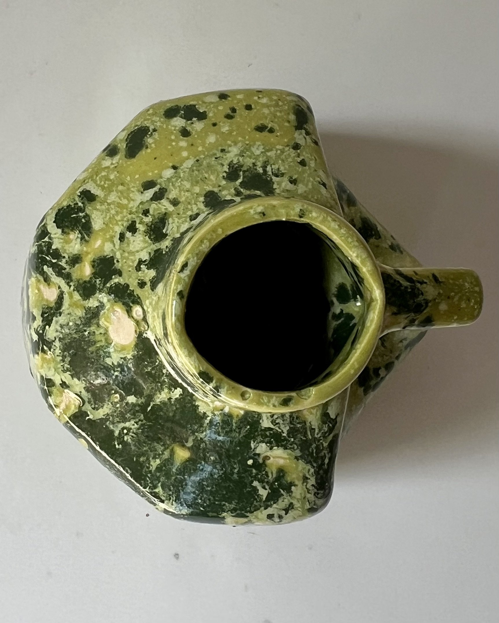 Top view of a handmade porcelain milk jug showing the opening and interior.