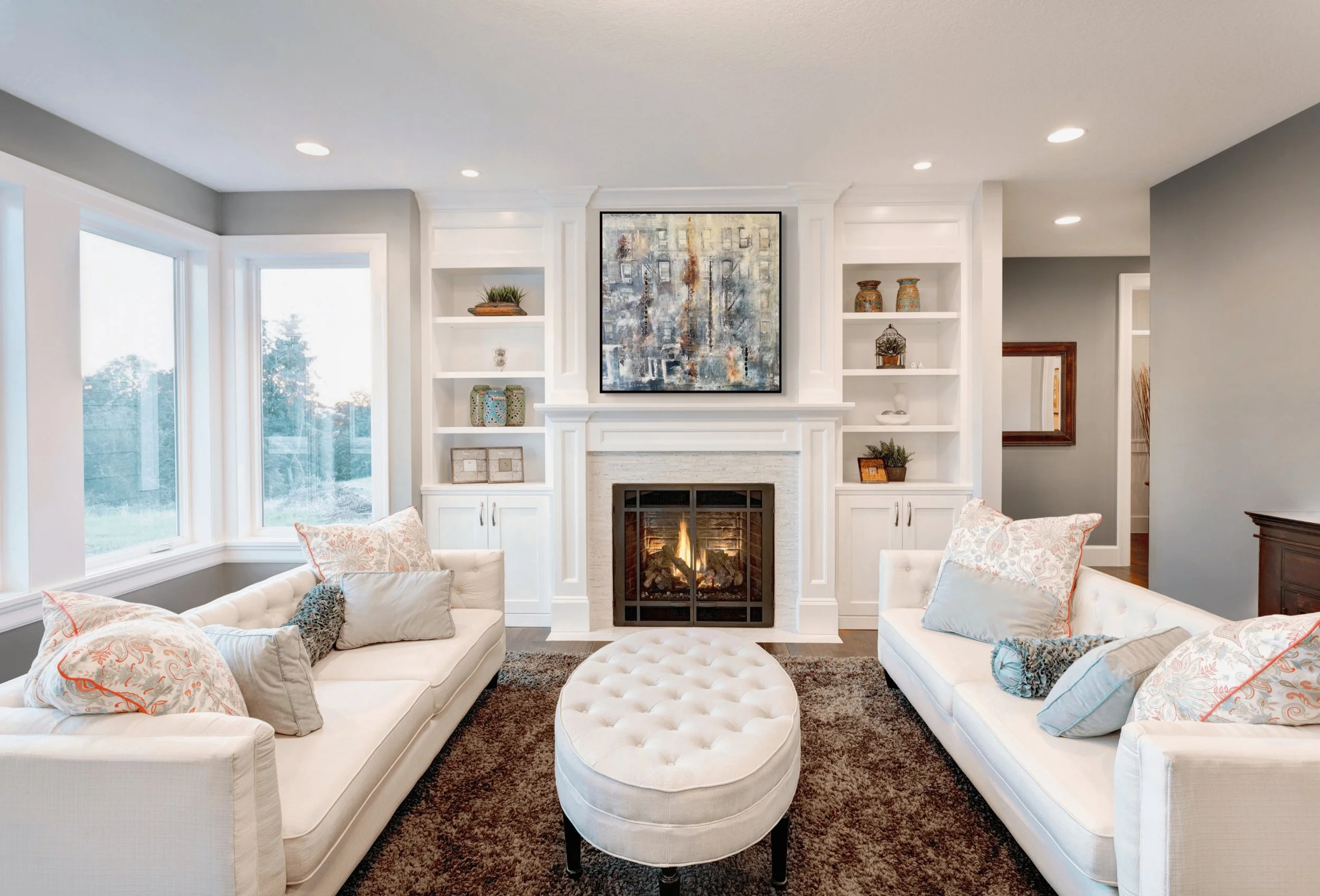 Indigo, an original abstract New York City painting by Alissa Van Atta, displayed above a sofa in a contemporary living room.