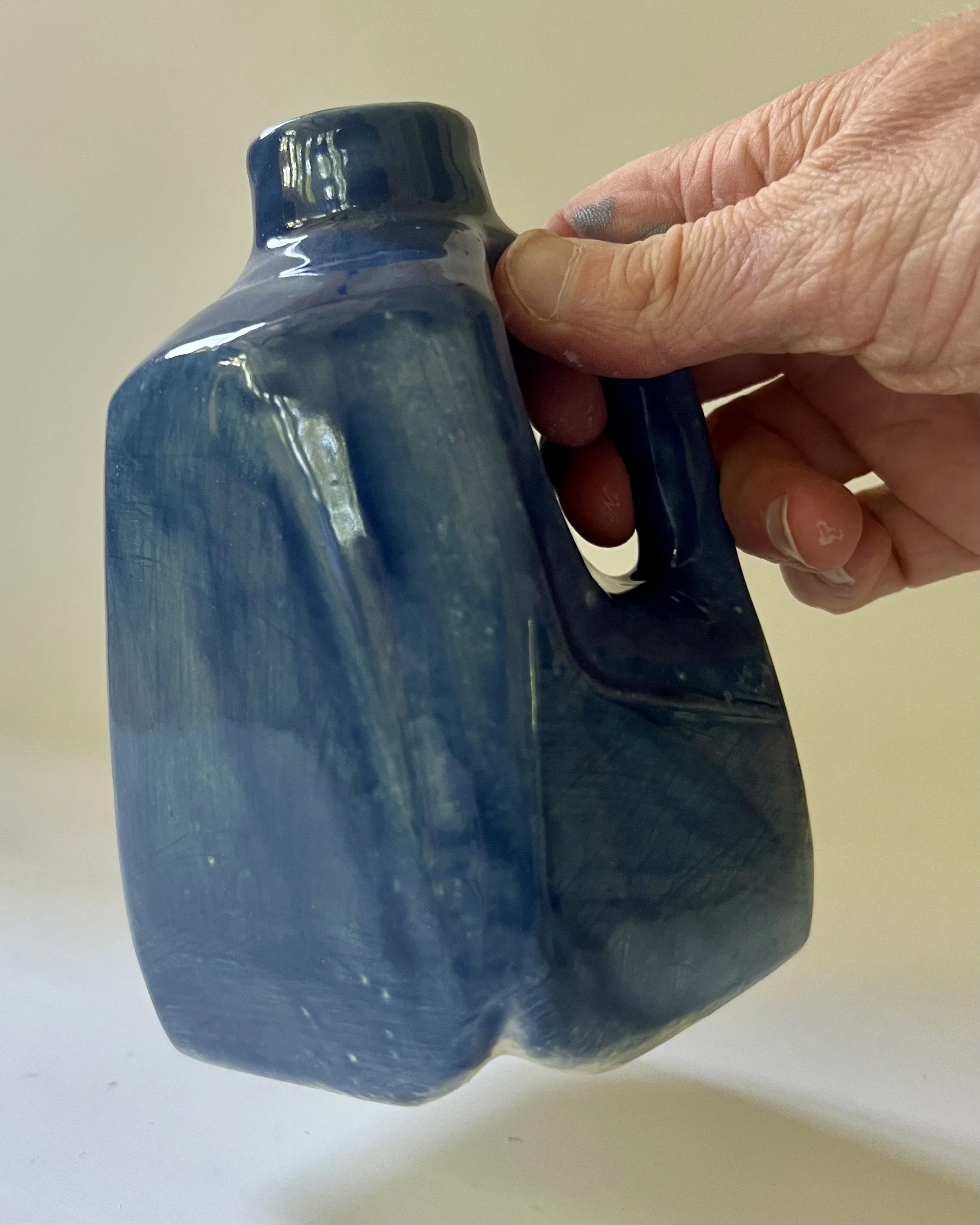 Handmade porcelain Milk Jug 26.55 shown in hand for scale