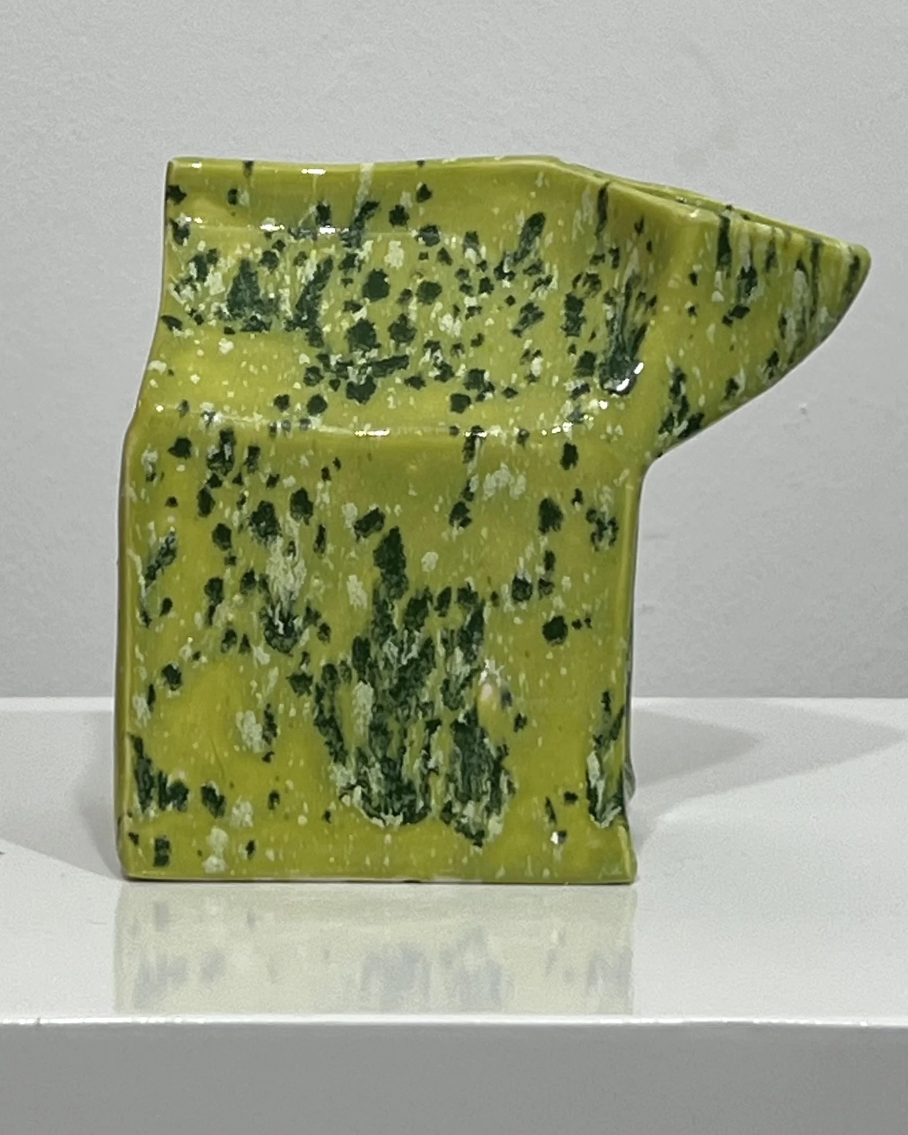 Side view of handmade porcelain milk carton sculpture with Lime Shower glaze and sculptural folded-carton silhouette.
