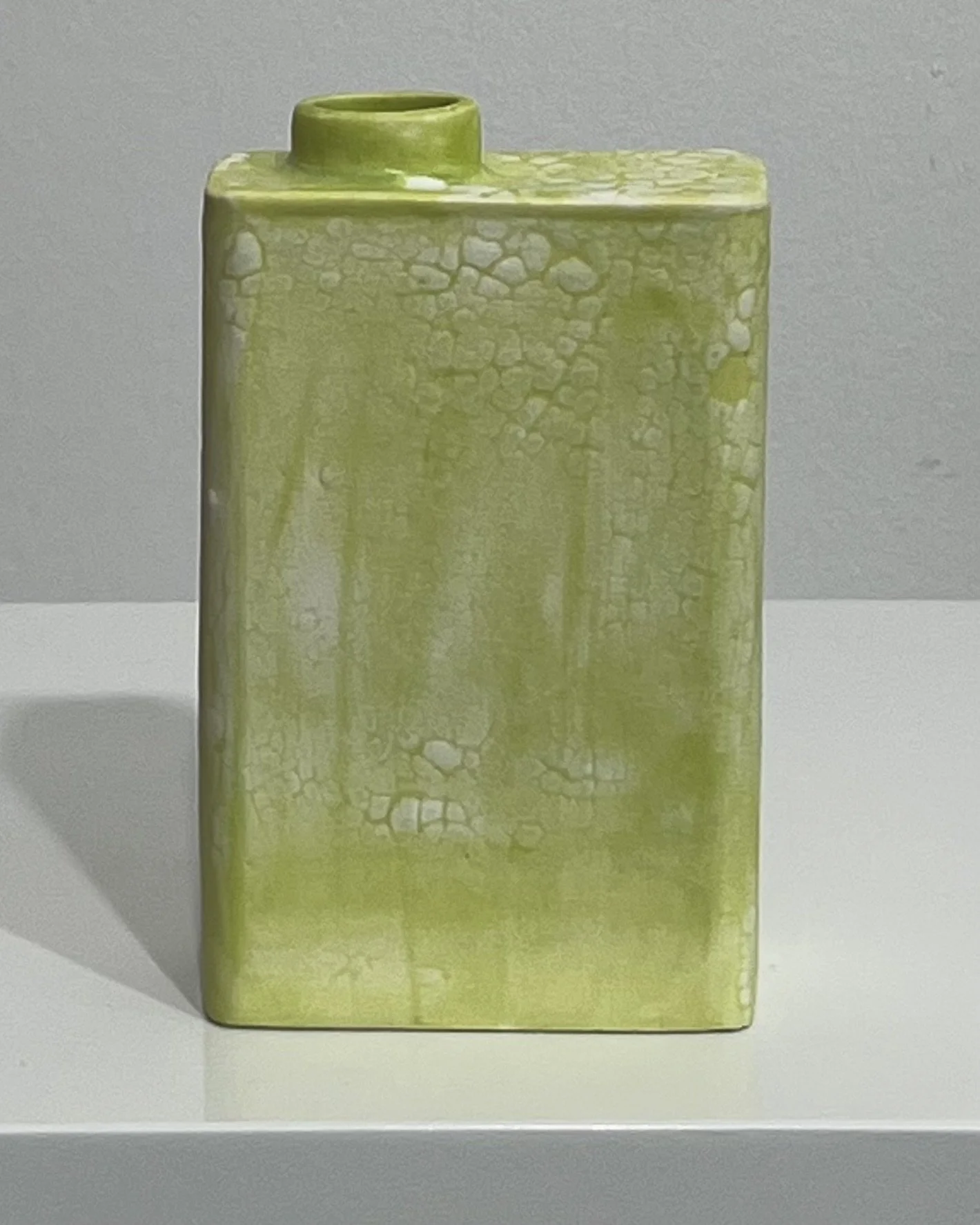 Front view of handmade porcelain Carton vessel with Chartreuse and Mudcrack glazes in yellow-green and cream.