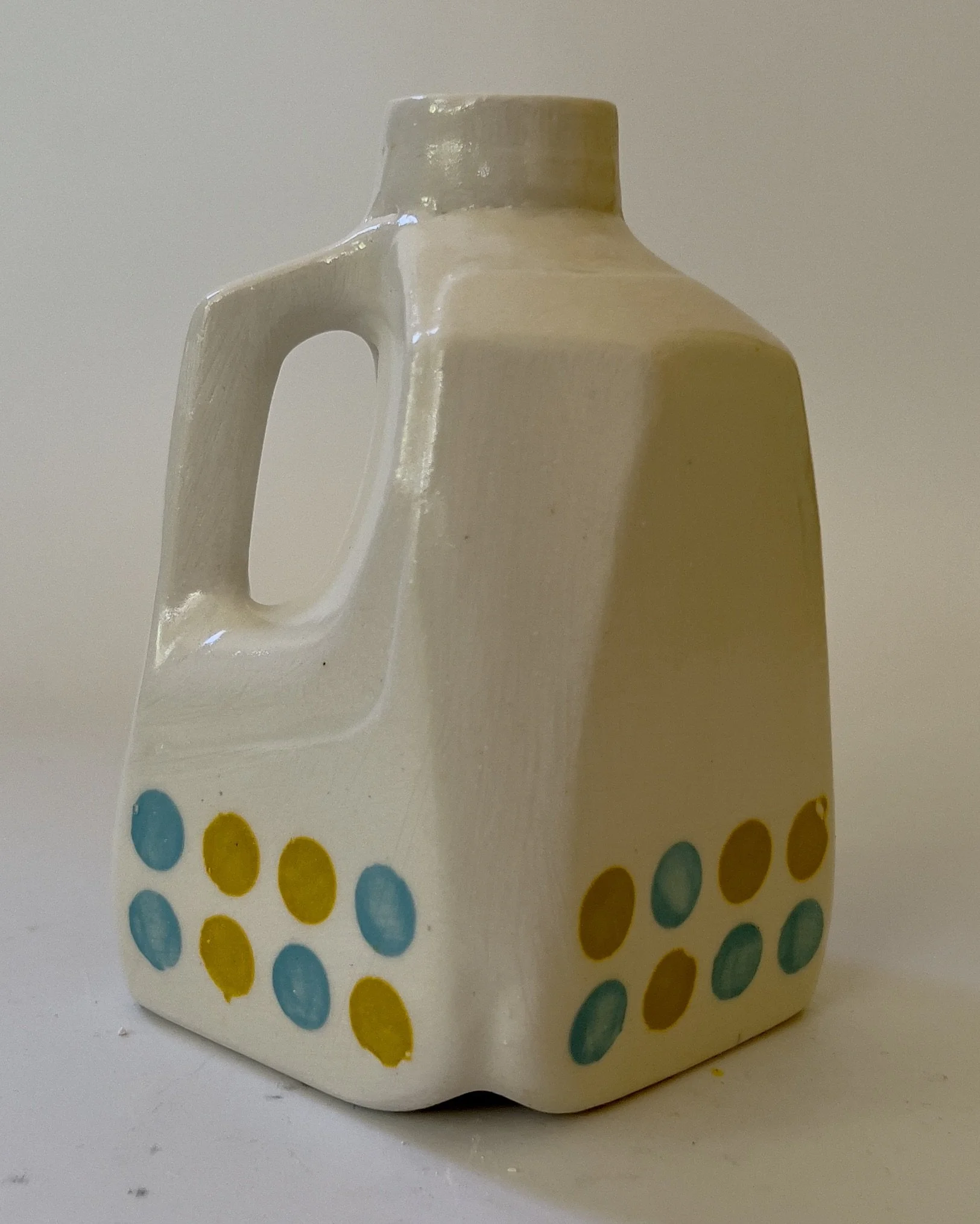Side view of handbuilt ceramic jug showing sculptural handle detail