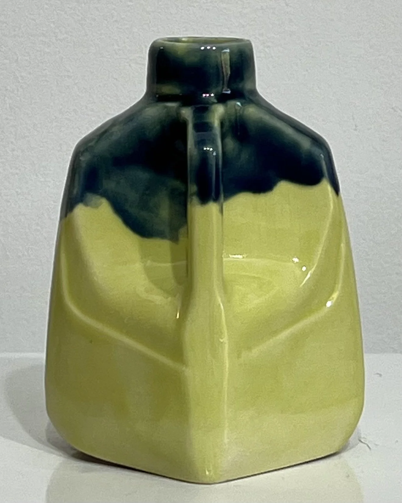 Right-side view of ceramic milk jug 26.123 showing its small handle and contrasting Pear and Deep Sea glazes