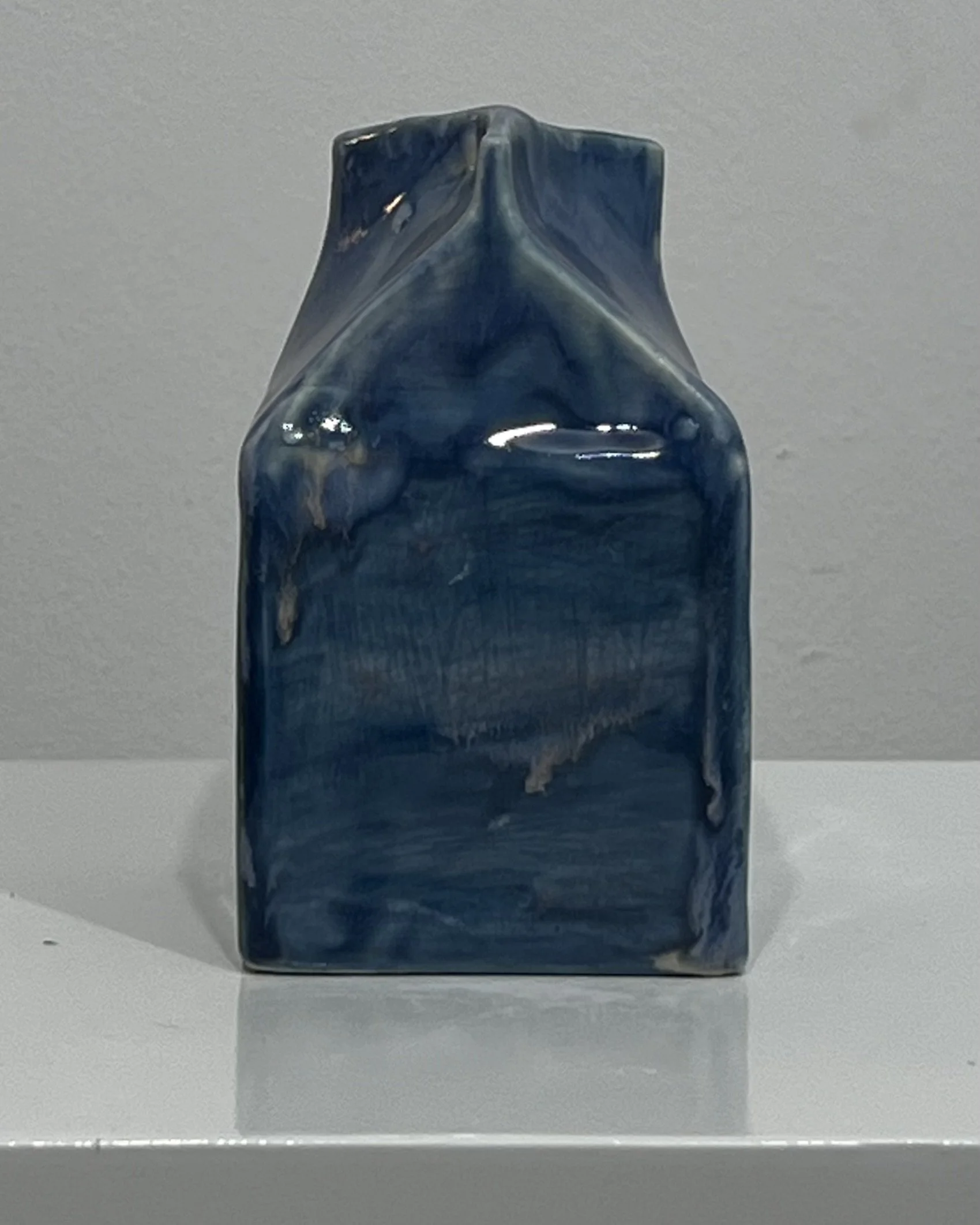 Back view of Milk Carton 26.2 Blue Splatter, a handmade porcelain vessel with deep blue glaze and subtle surface variation.