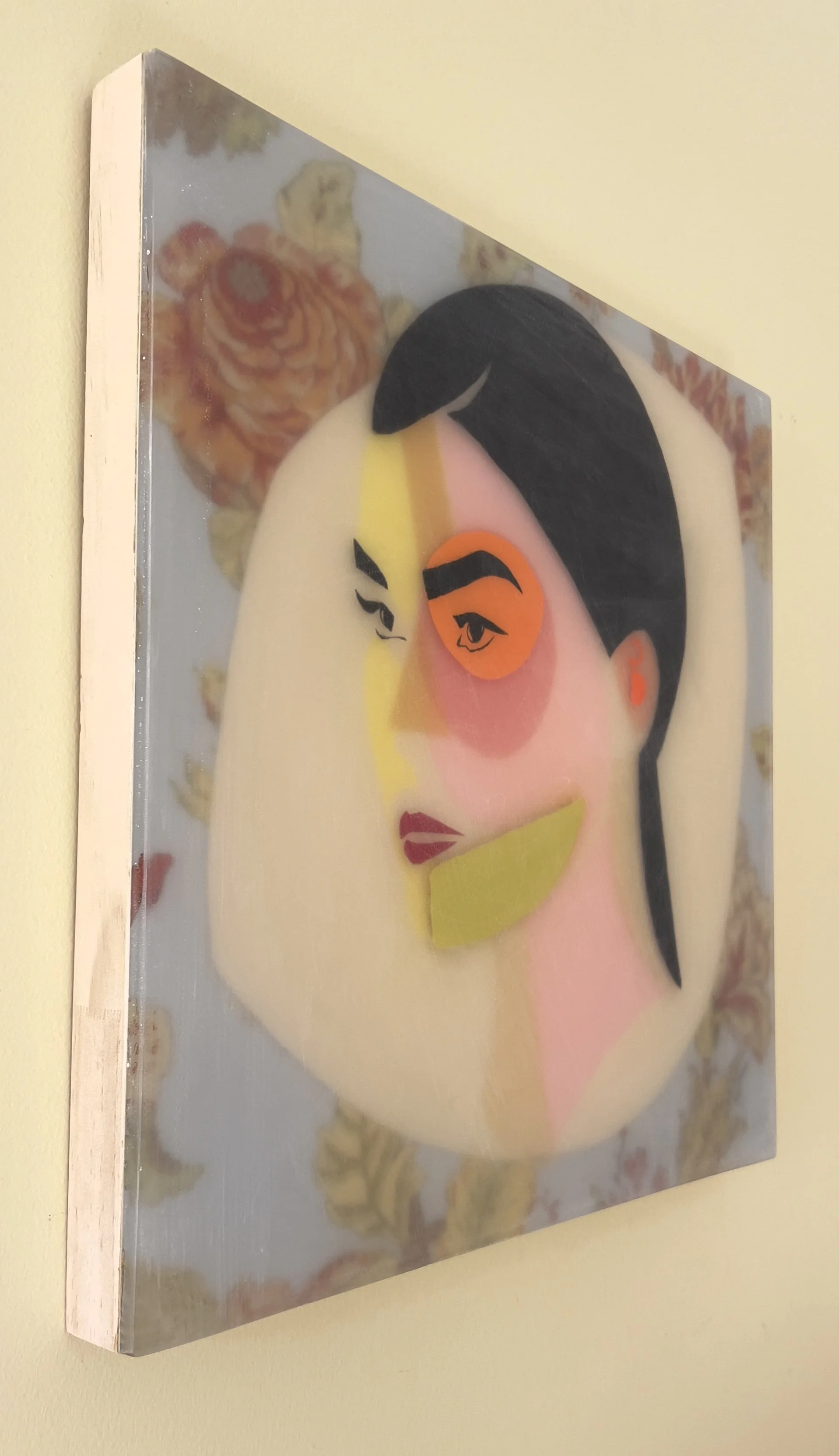 Angled view of Adeline showing the dimensional mixed media portrait on cradled wood