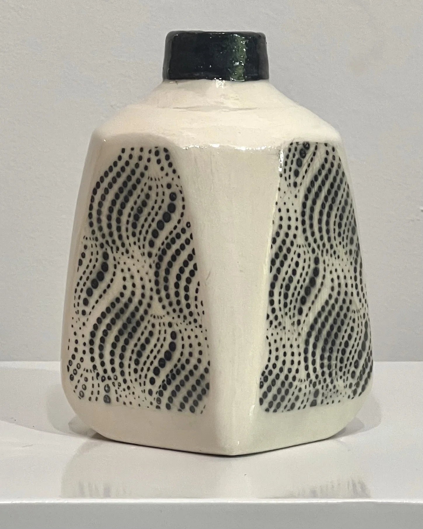 Porcelain milk jug vase showing integrated handle and glossy cream glaze.