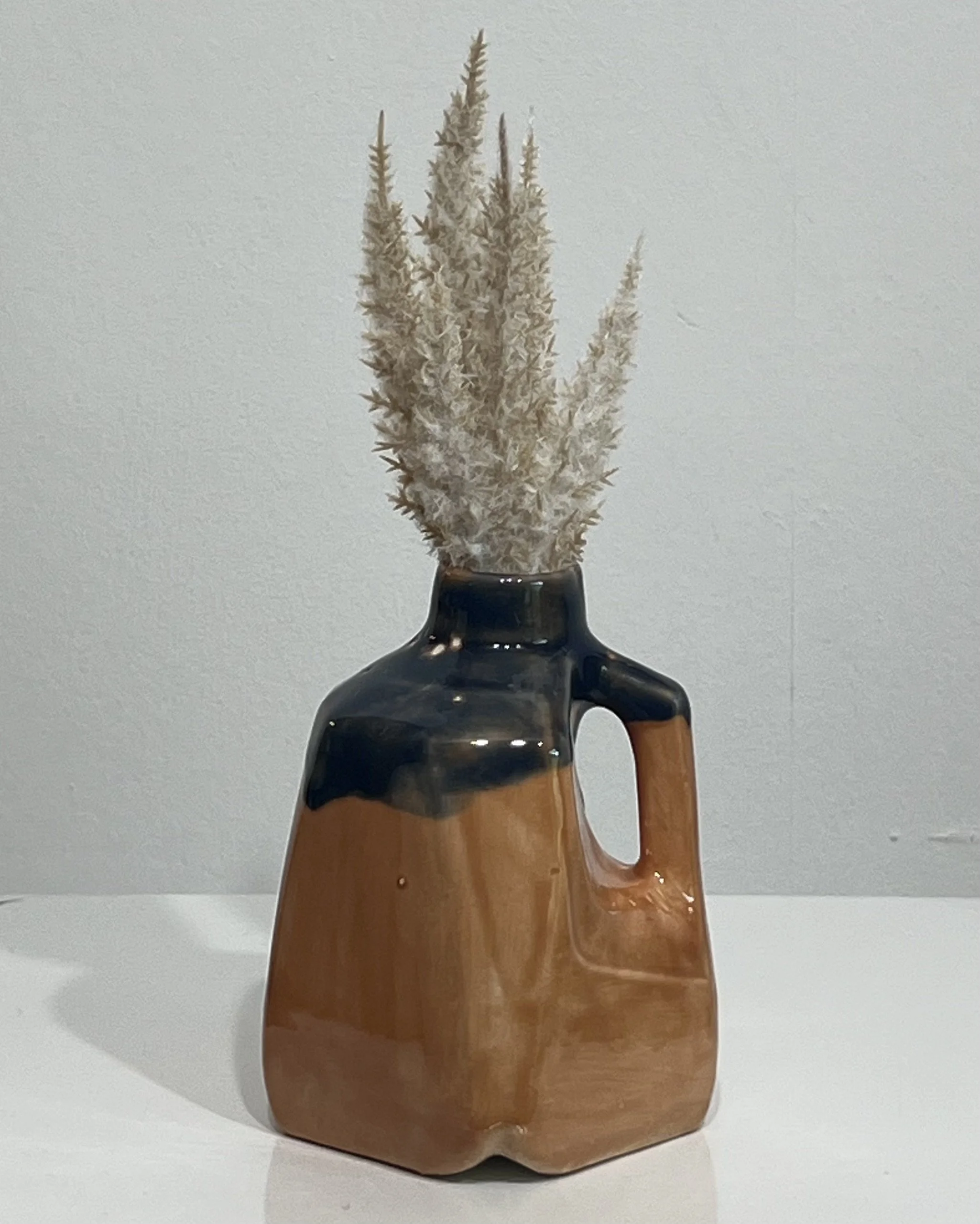Sandalwood and Deep Sea porcelain milk jug vase with dried stems by Alissa Van Atta