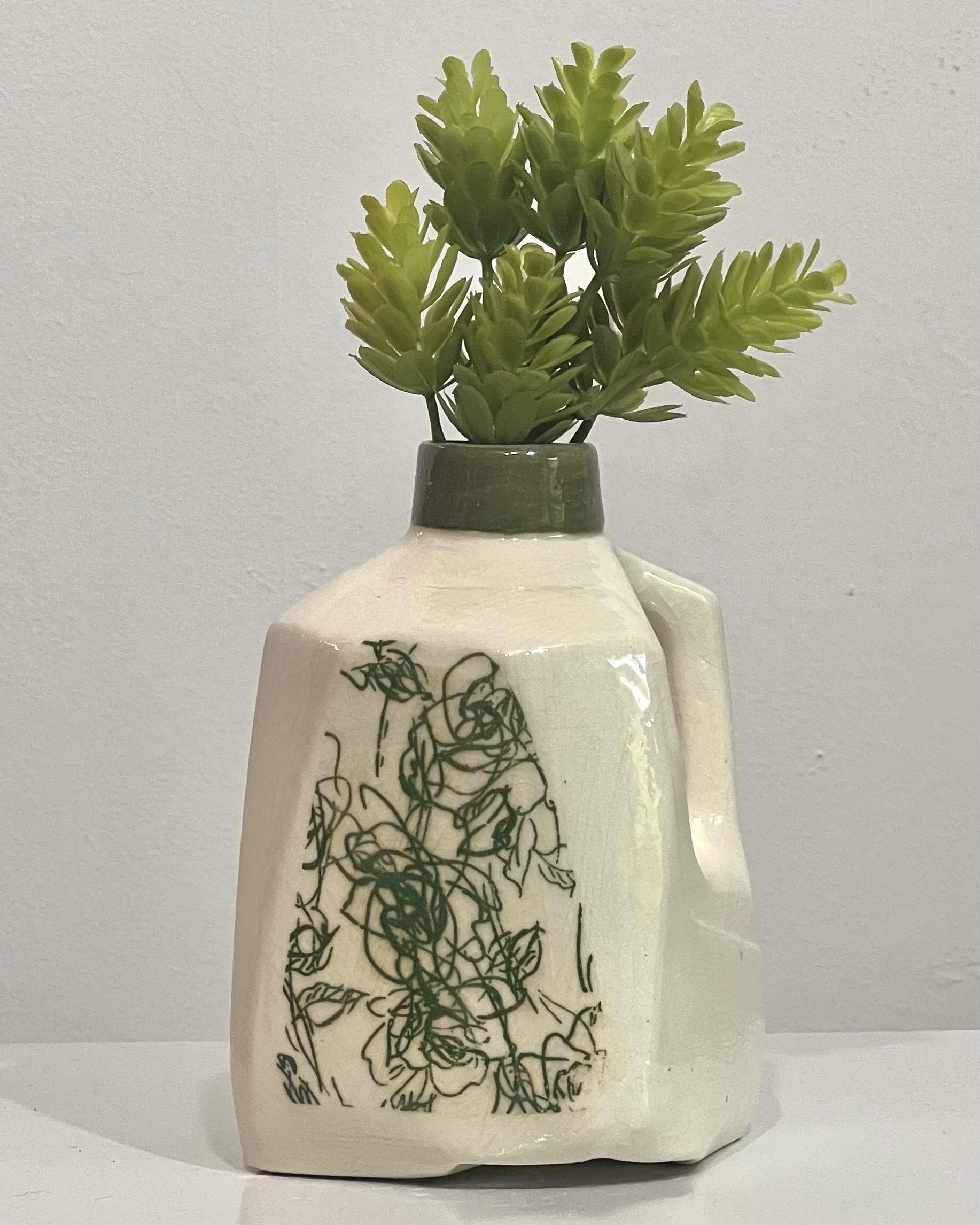 Verdant Sketch porcelain milk jug vase with green botanical transfer and glossy clear glaze holding small green stems.