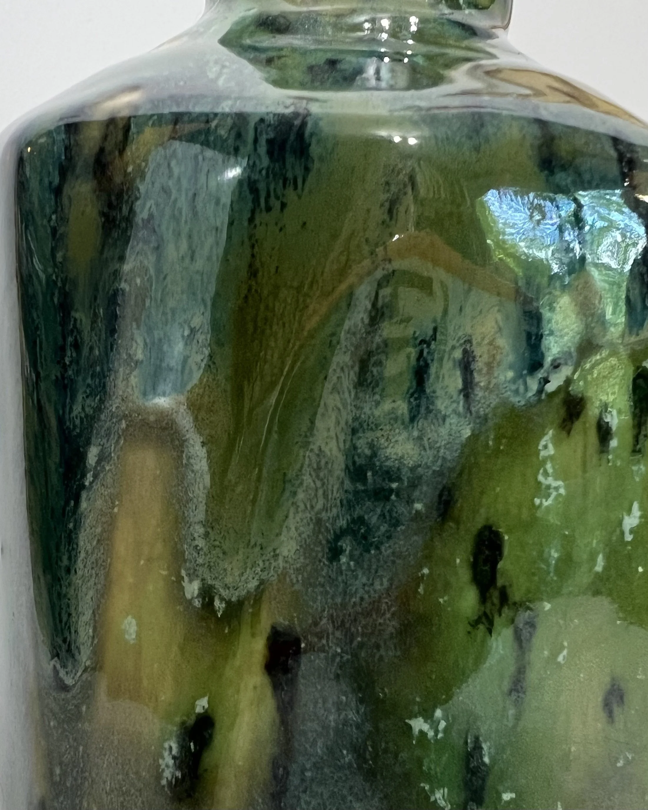 Close-up of Lime Shower and Seaweed ceramic glazes showing vibrant blue, turquoise, and lime-green variations.