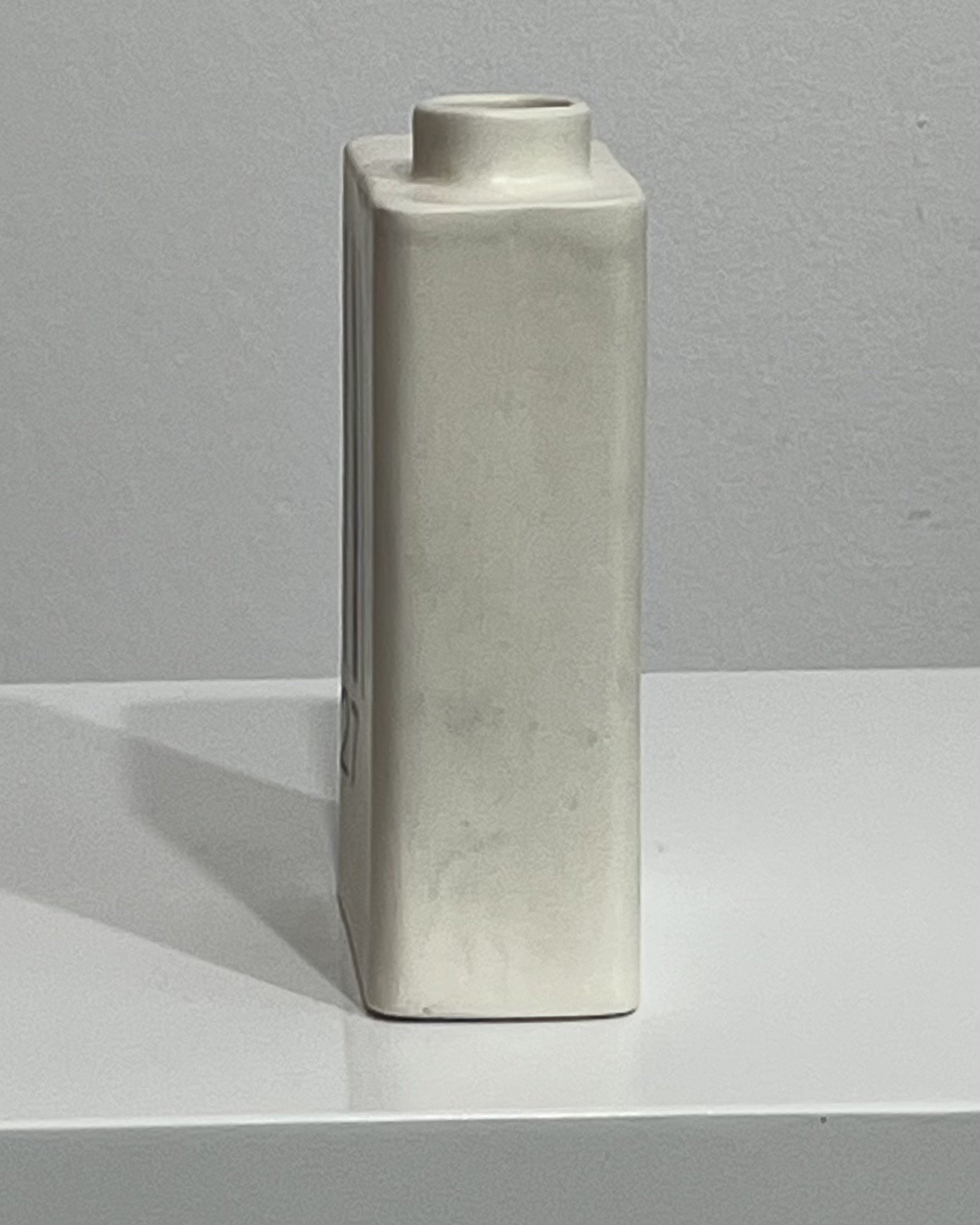 Back view of white porcelain milk carton sculpture