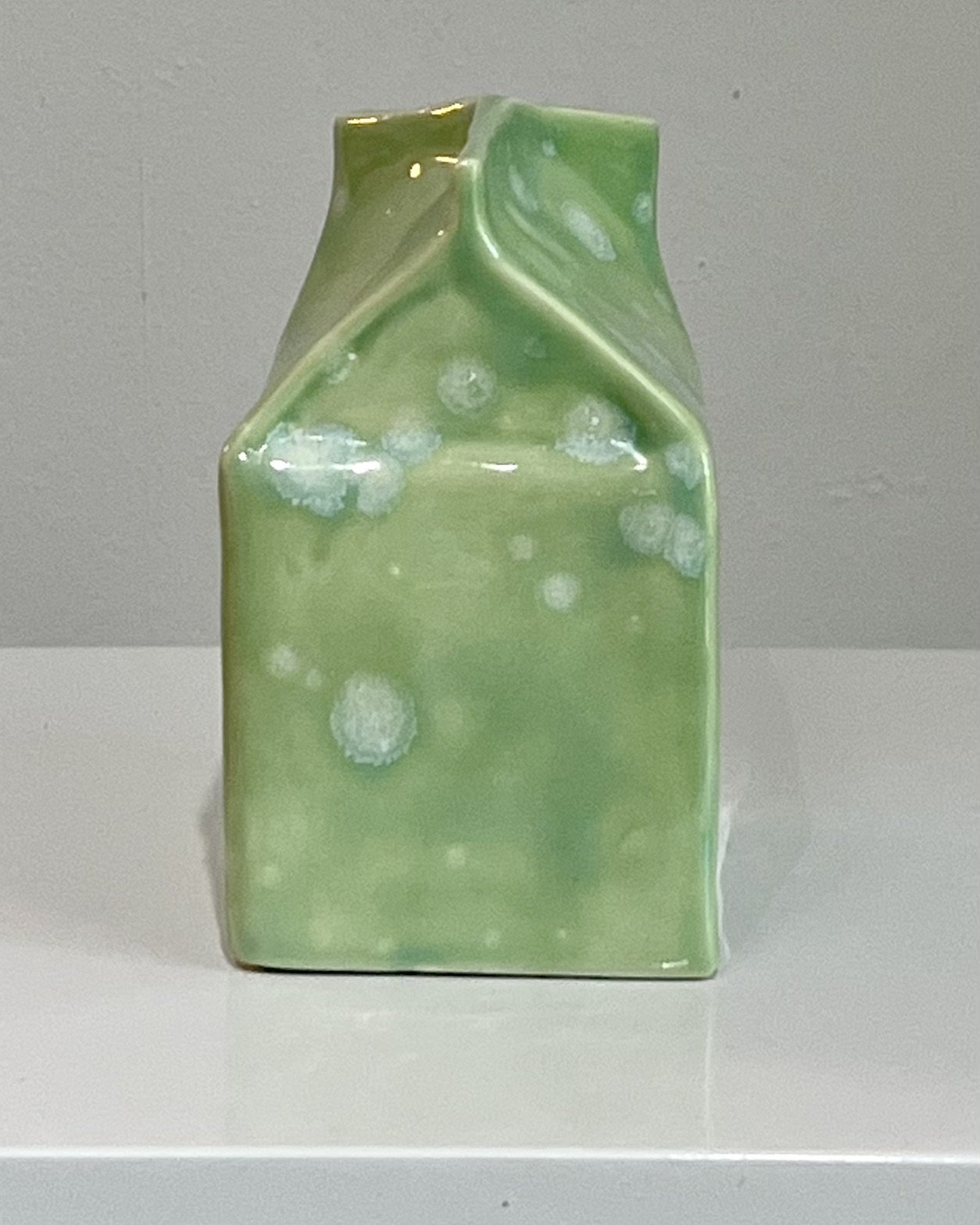 alissa-van-atta-milk-carton-mcSide profile of one-of-a-kind porcelain milk carton sculpture with folded carton form.