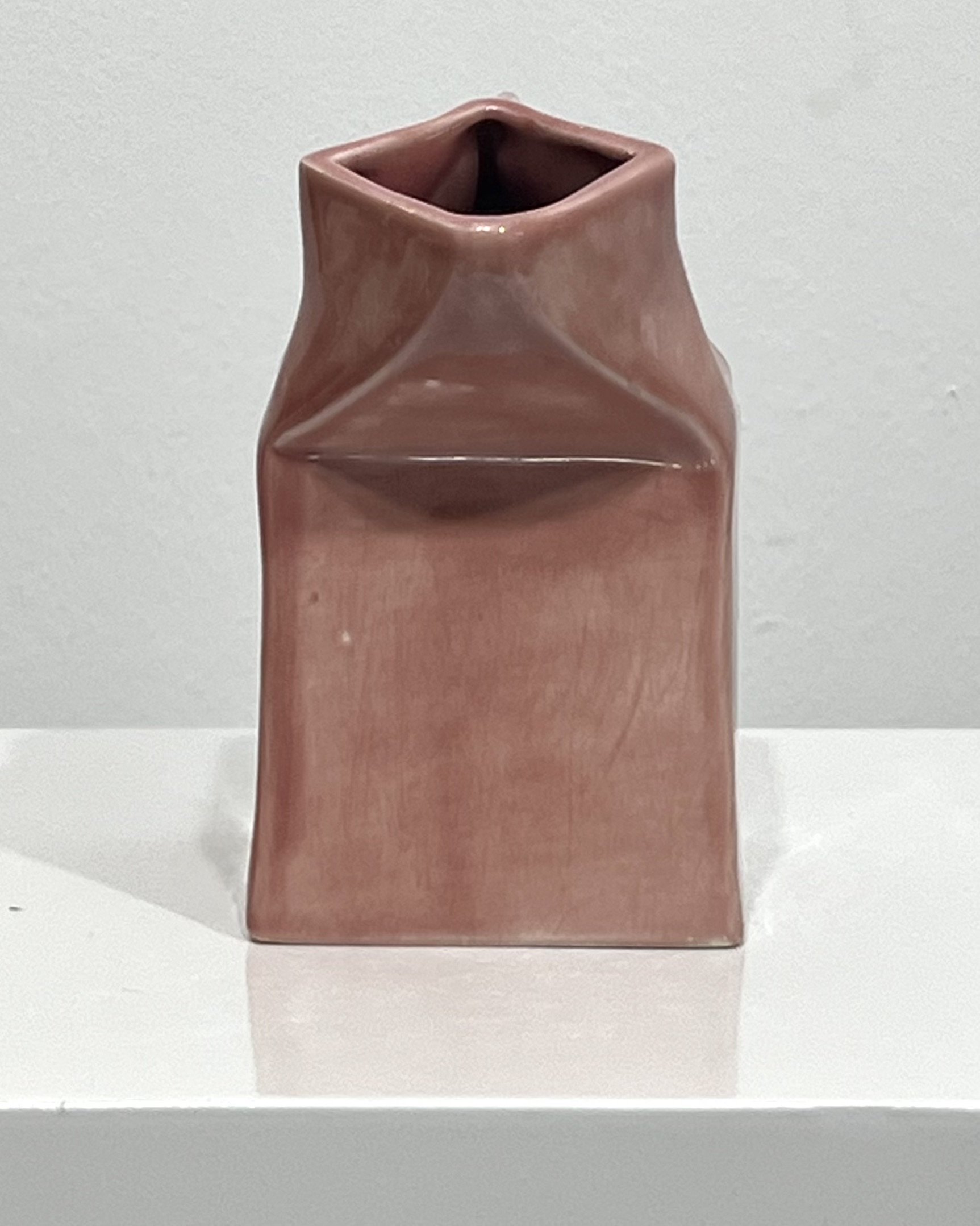 Blush porcelain milk carton sculpture front view handmade contemporary ceramic vessel approximately 6 inches tall.