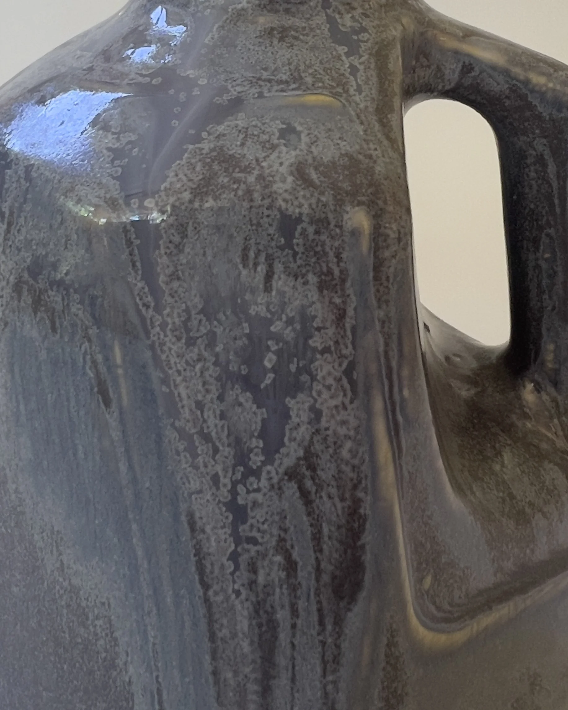 Close detail of layered Nimbus glaze with flowing mineral-like texture on handmade ceramic vessel