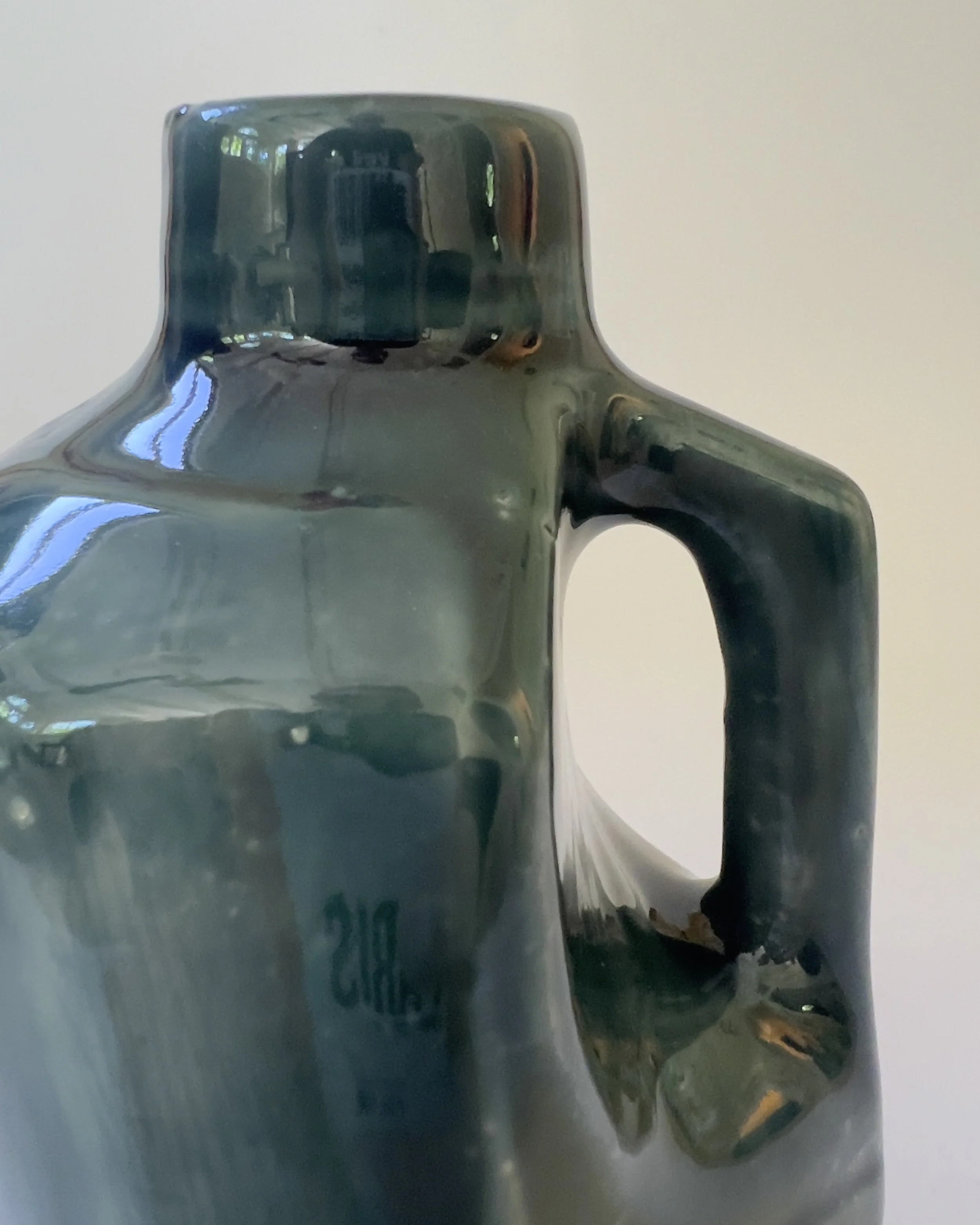 Close-up detail of handle and glossy rainforest glaze on ceramic jug