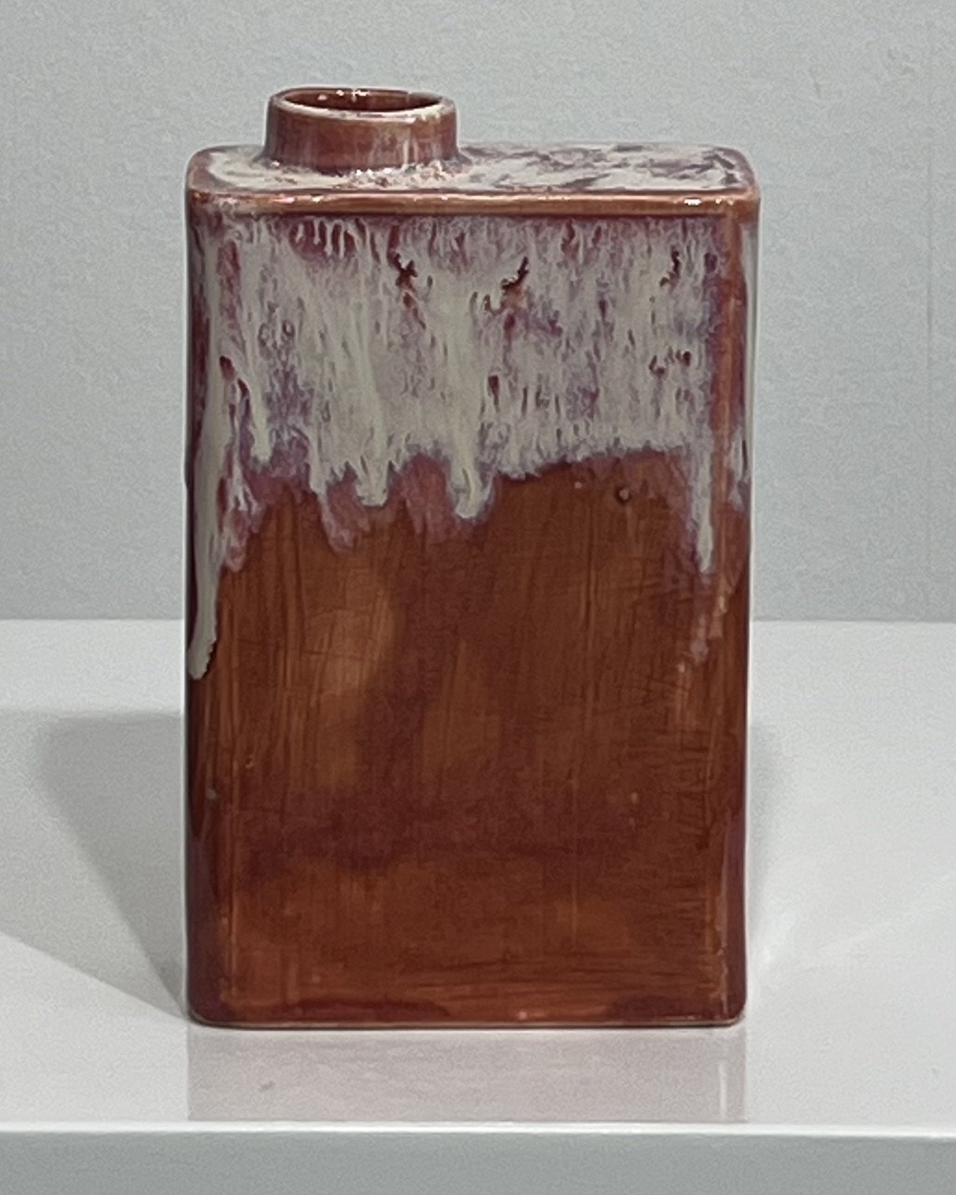 Front view of ceramic carton with rust-red Chun Plum glaze and cascading cream Light Flux
