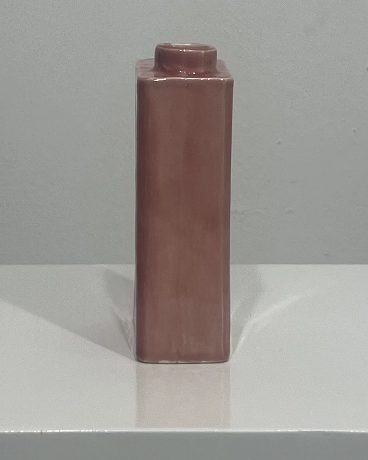 Side profile of porcelain carton vase in glossy Weeping Plum glaze.