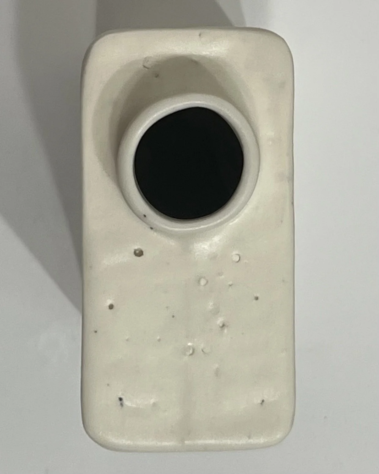 Top view of porcelain milk carton showing circular opening and textured white surface