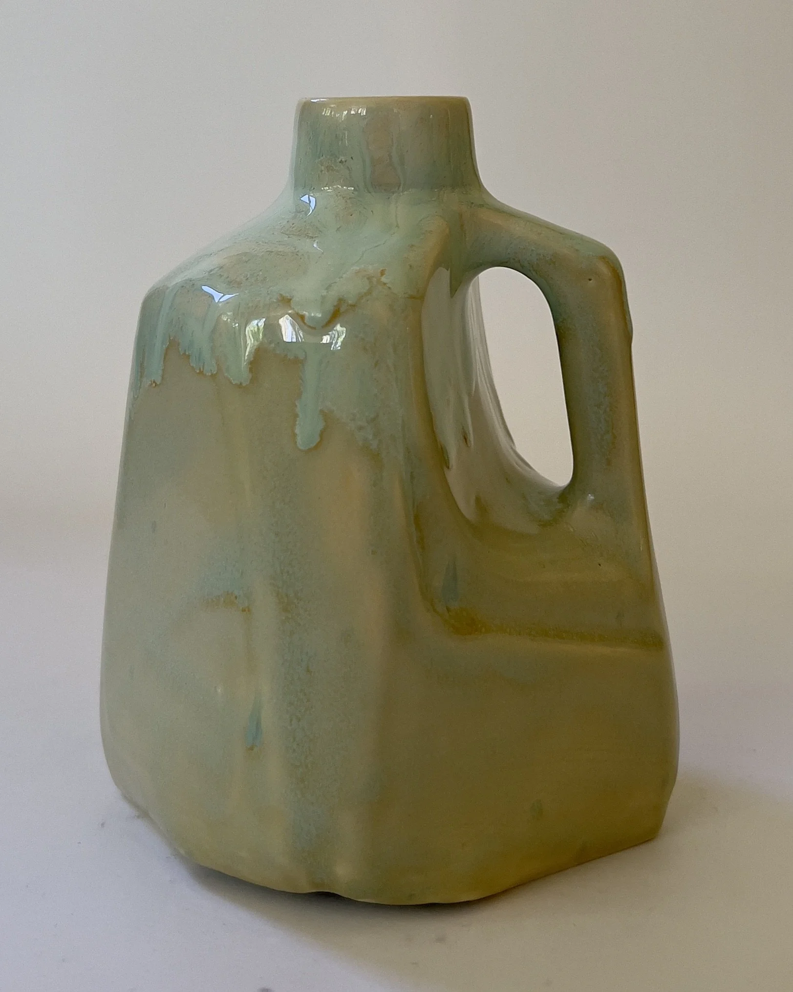 Handmade ceramic milk jug vase with pale celadon and aqua flowing glaze details