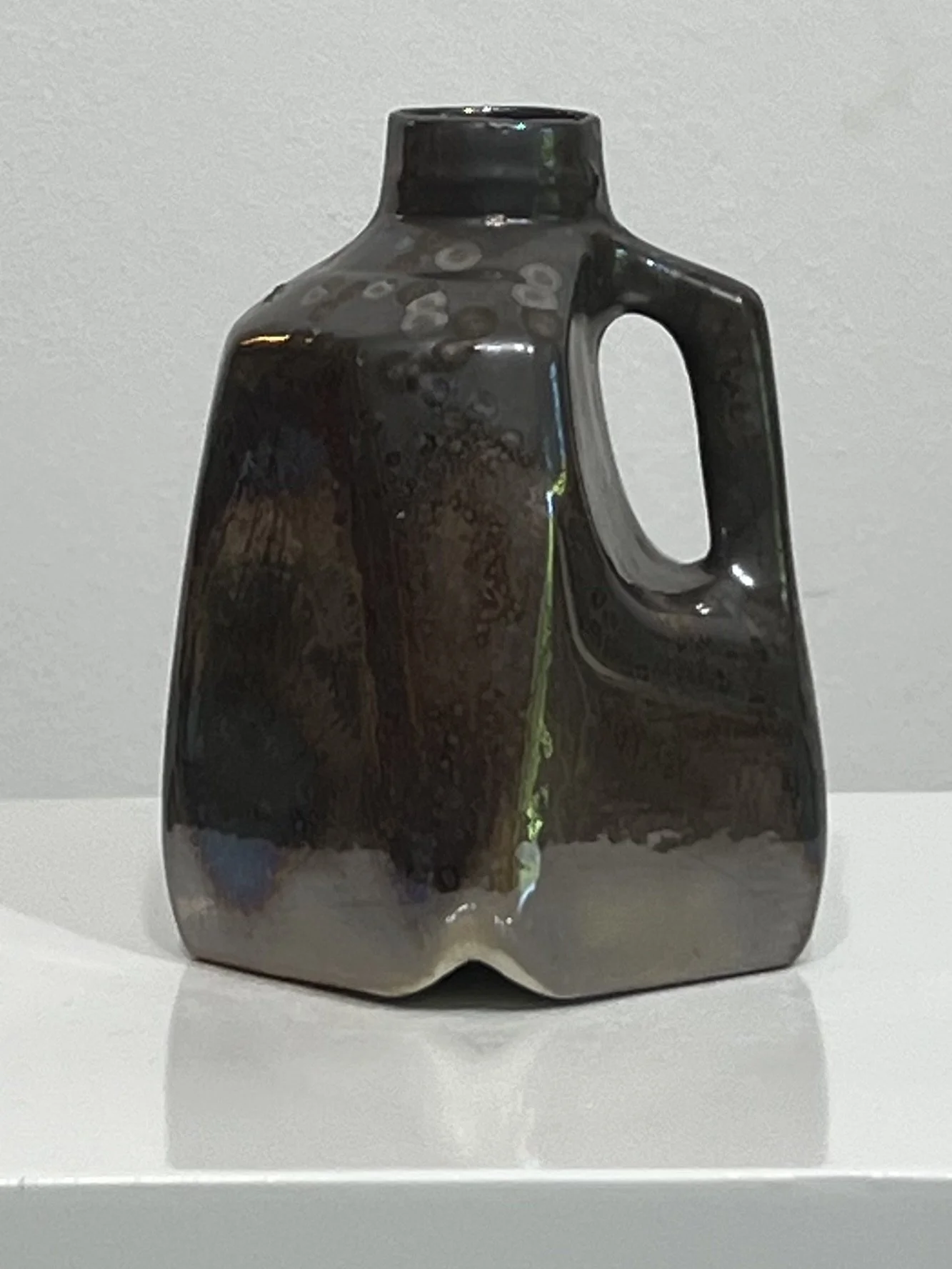 Front view of porcelain milk jug vase in Vintage Gold glaze