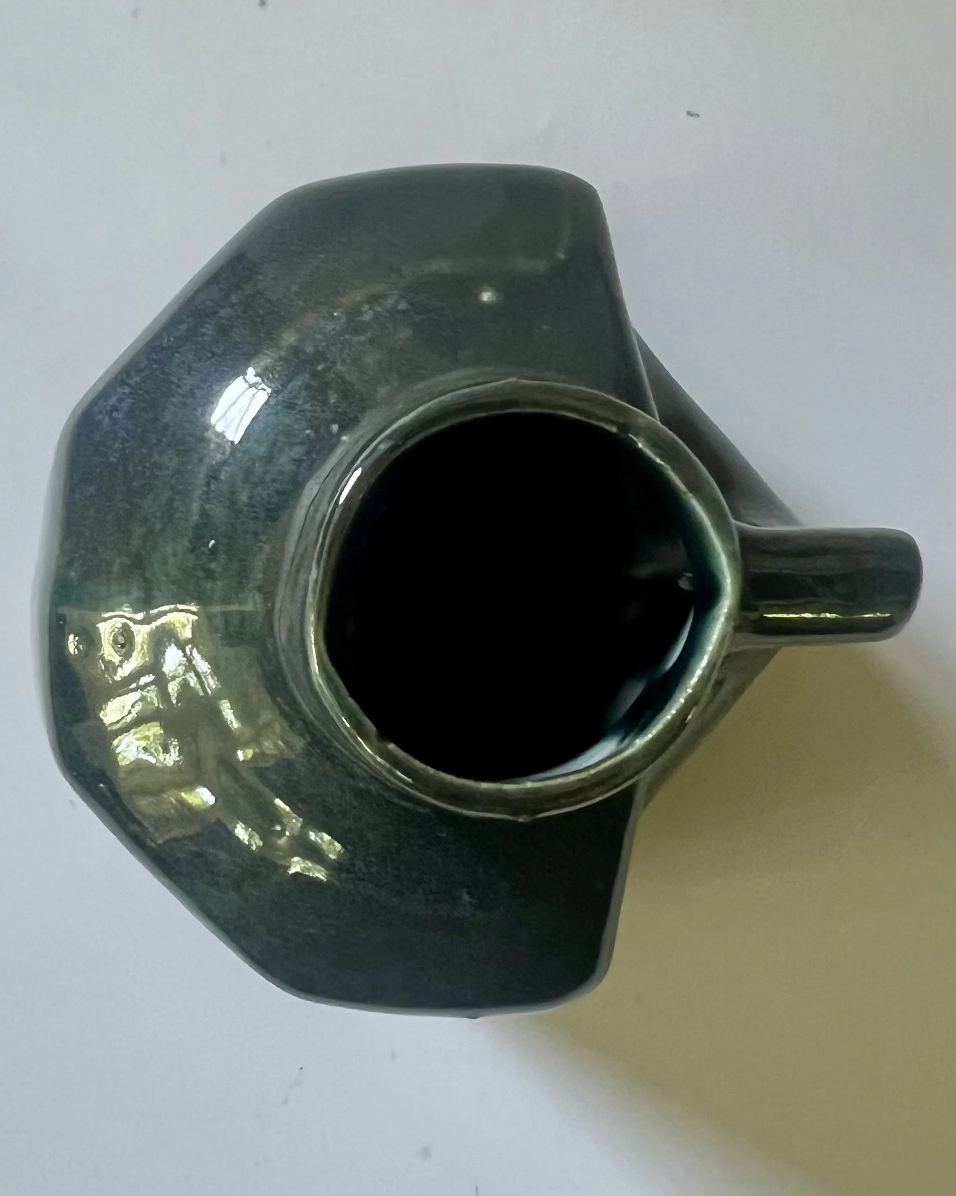 Top view of handmade porcelain milk jug vase showing circular opening and glossy layered glaze surface.