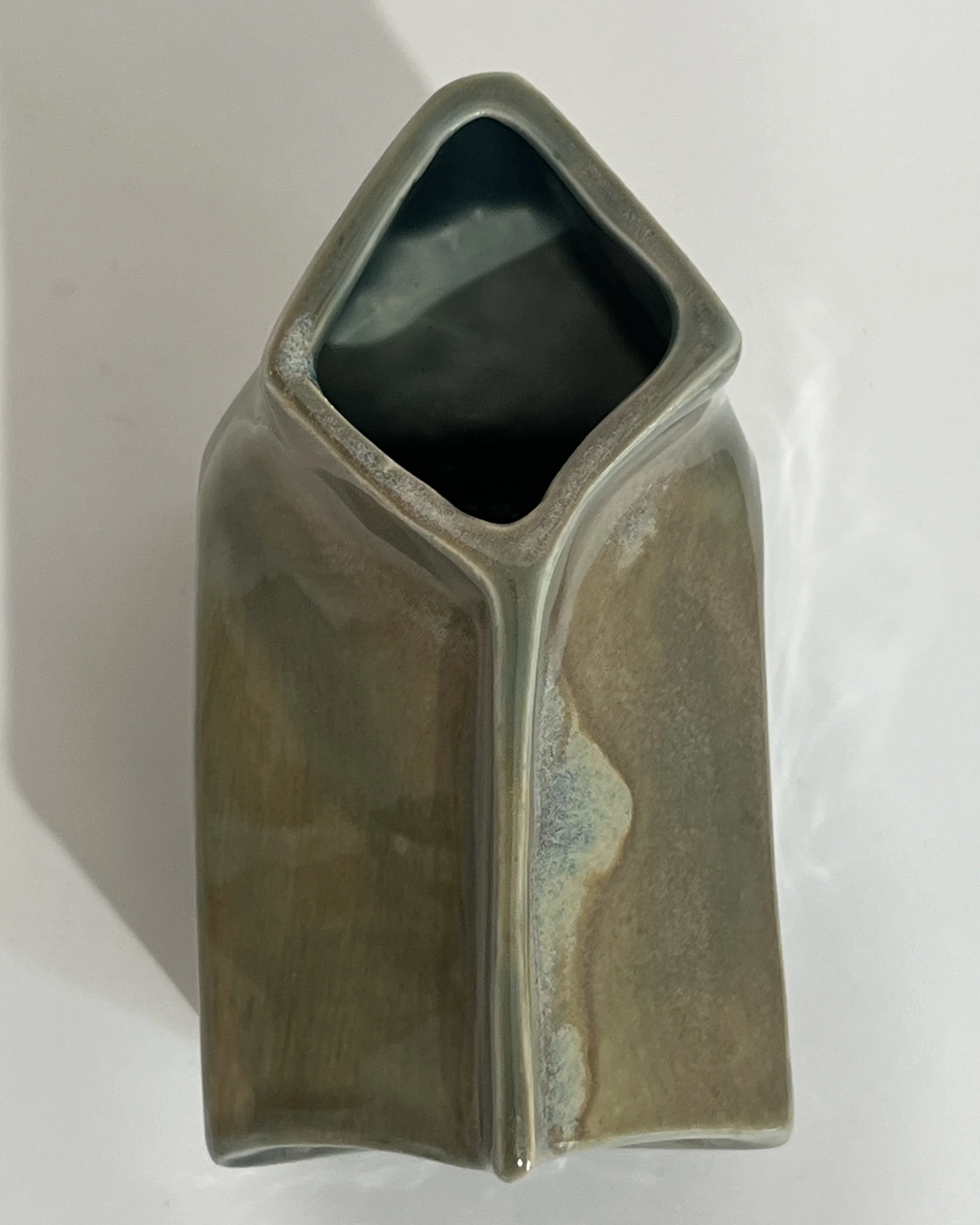 Top view of ceramic milk carton showing the angular opening and glazed interior.