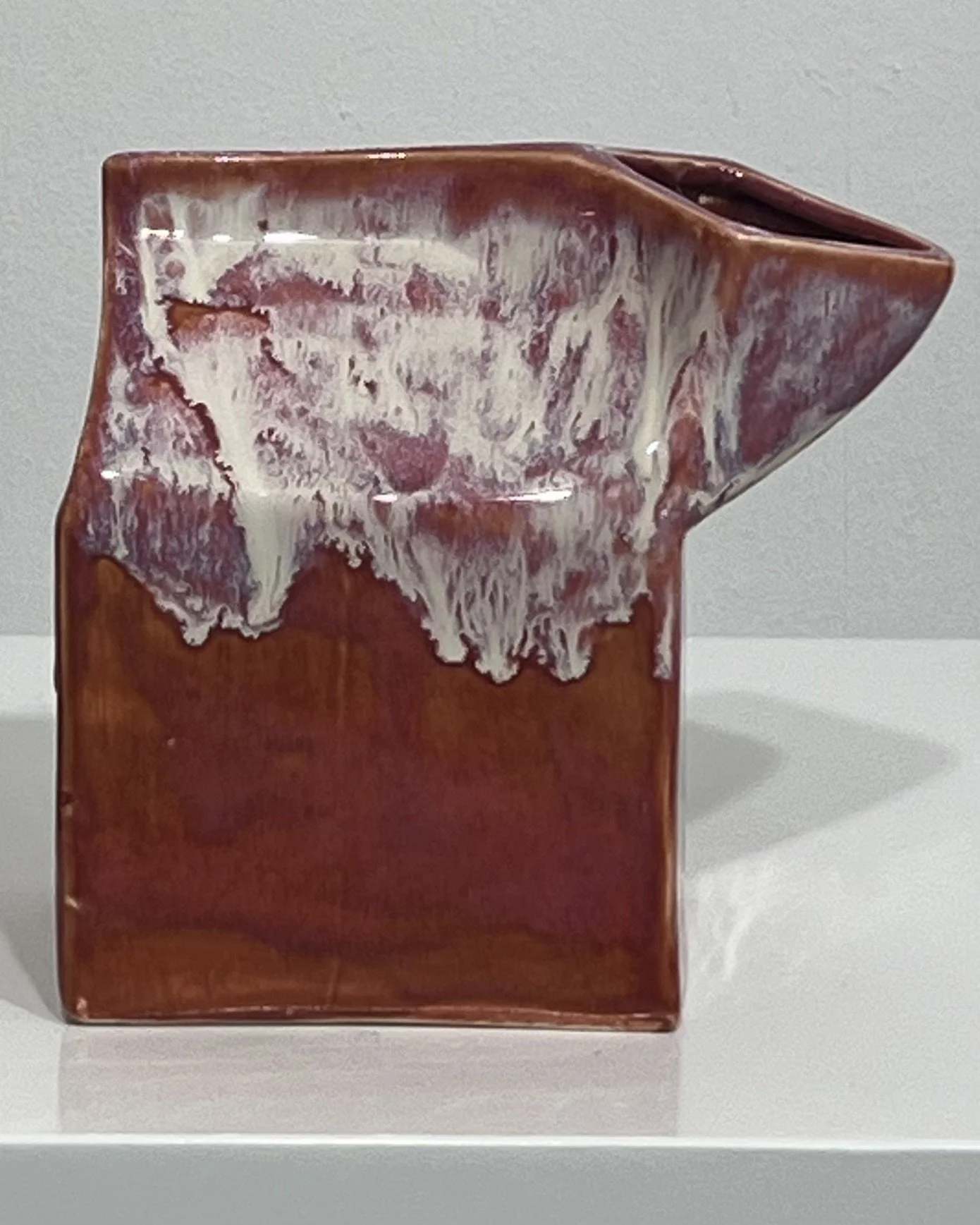 Front view of a handmade ceramic milk carton vase with Chun Plum glaze and creamy Light Flux drips.