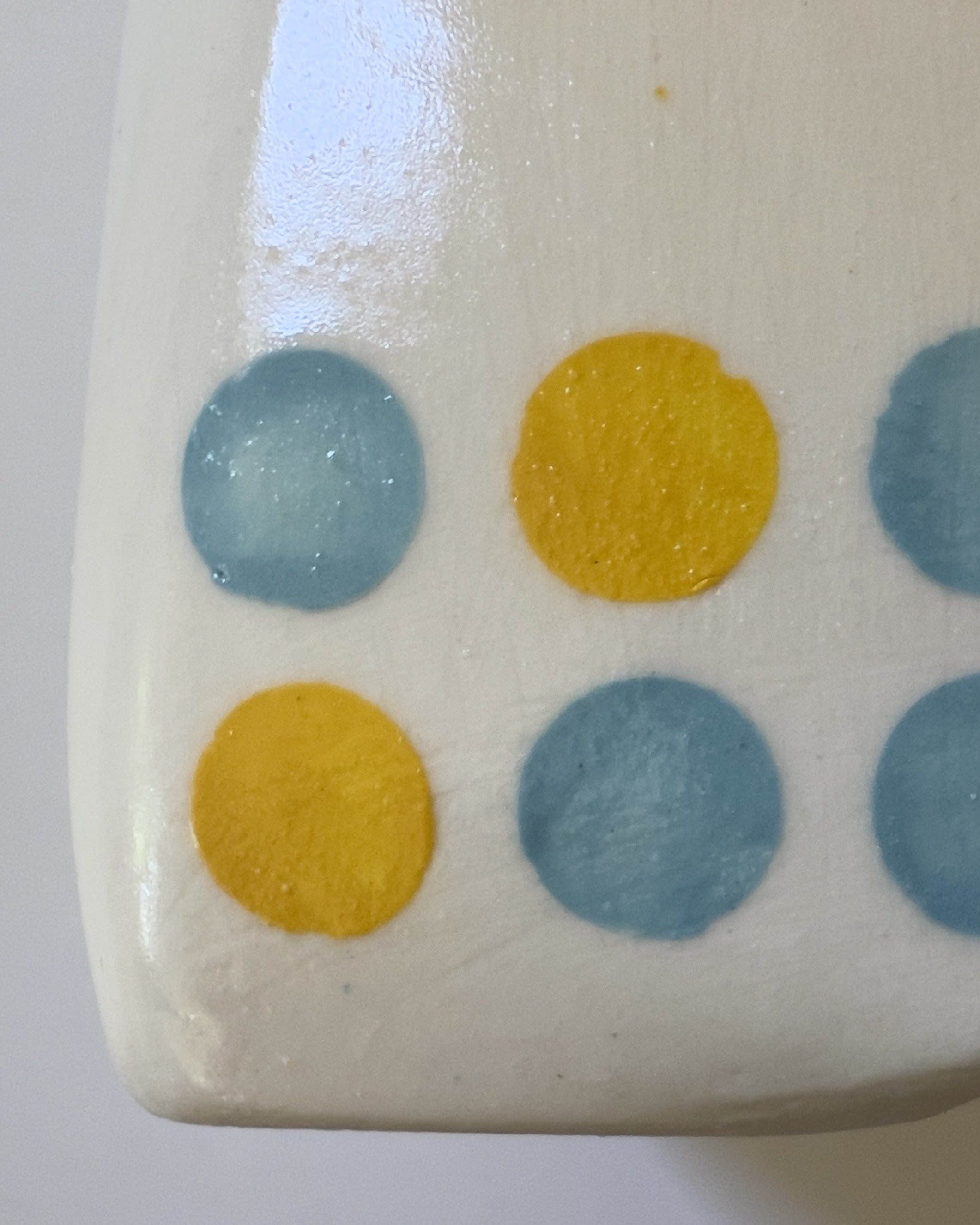 Close-up detail of jade and dandelion dot glaze on ceramic jug sculpture