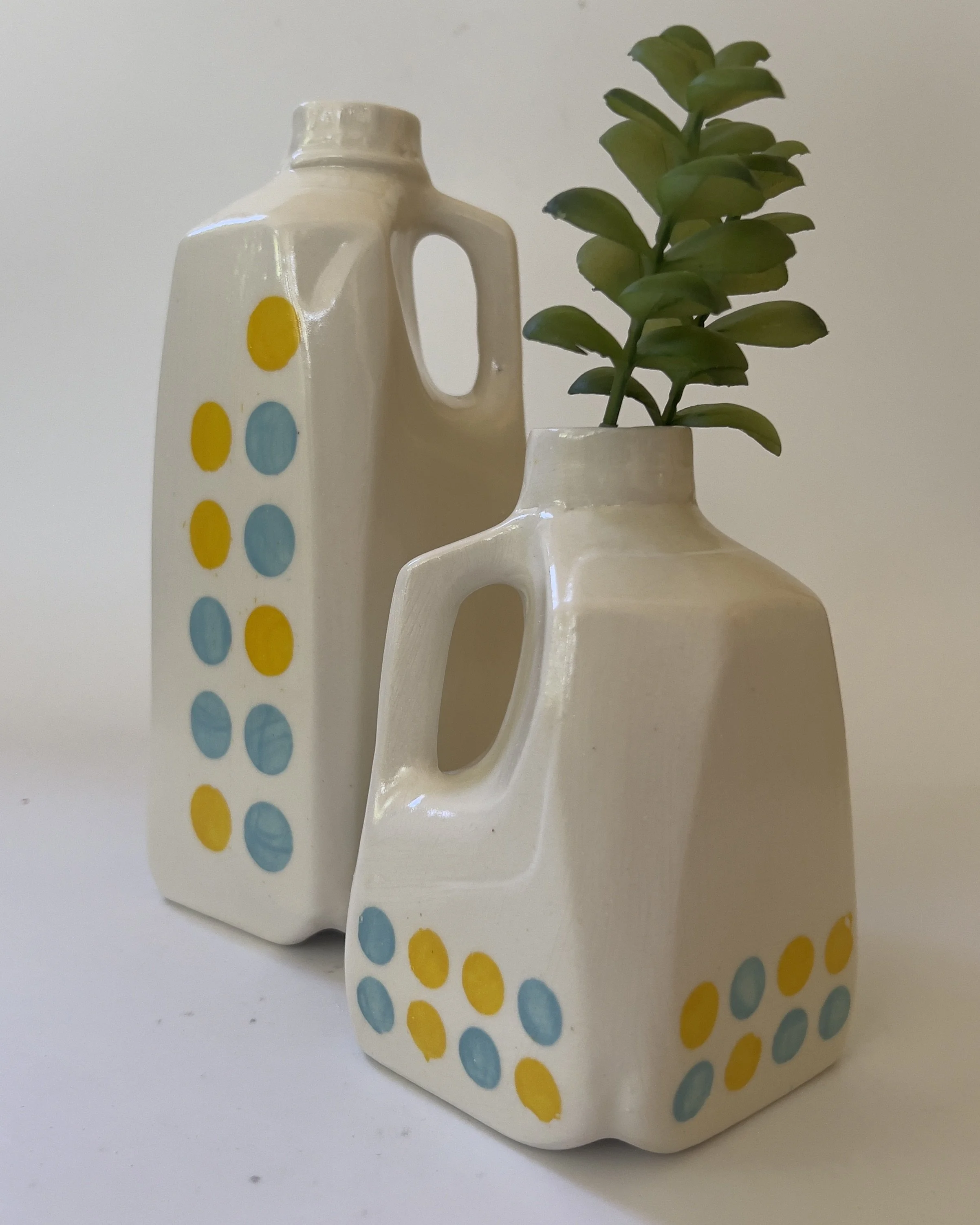 Tall ceramic jug vase displayed beside matching smaller ceramic vase