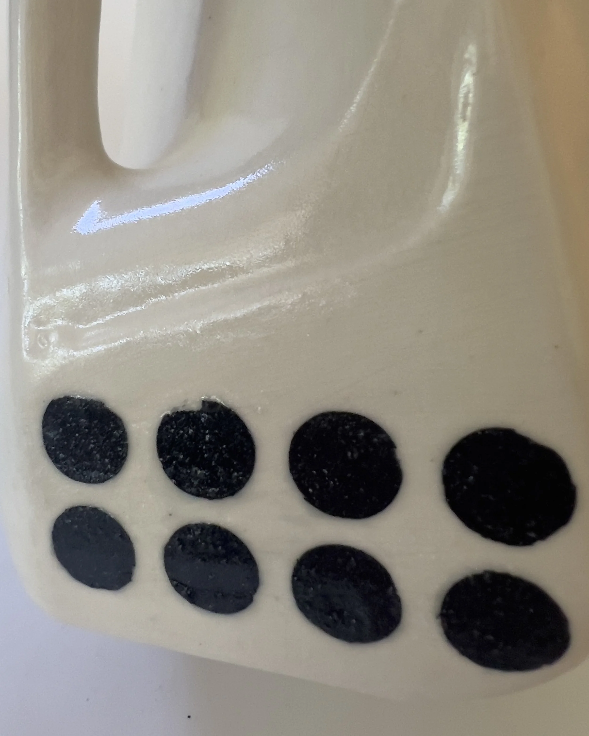 Gloss glaze and handle detail on ceramic milk jug