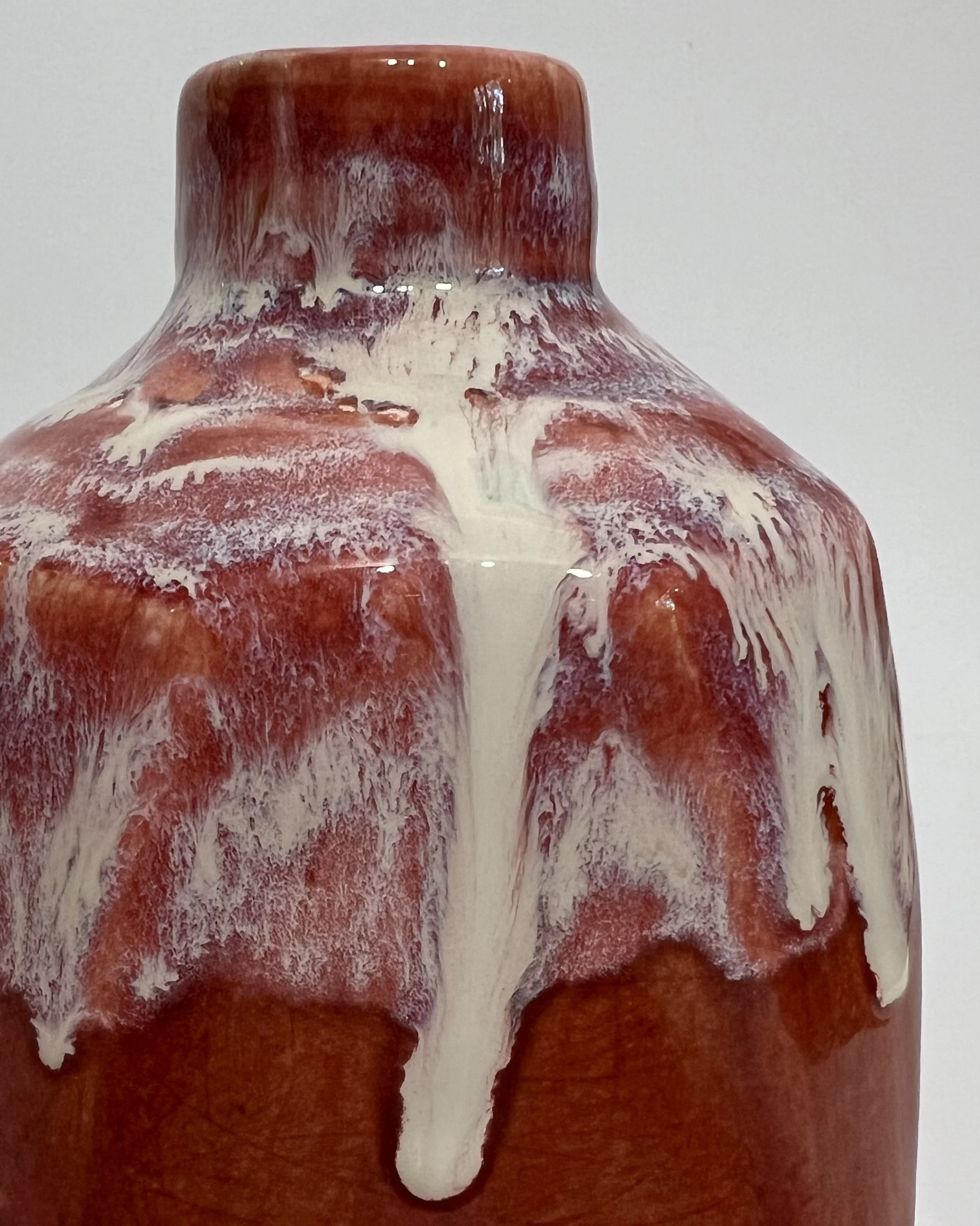 Close-up of creamy Light Flux glaze flowing over deep red Chun Plum glaze