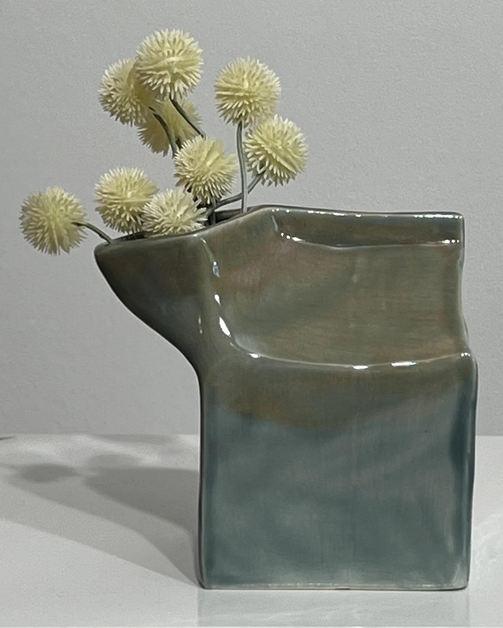 Fog and Mystic Tide ceramic milk carton styled with dried yellow flowers.