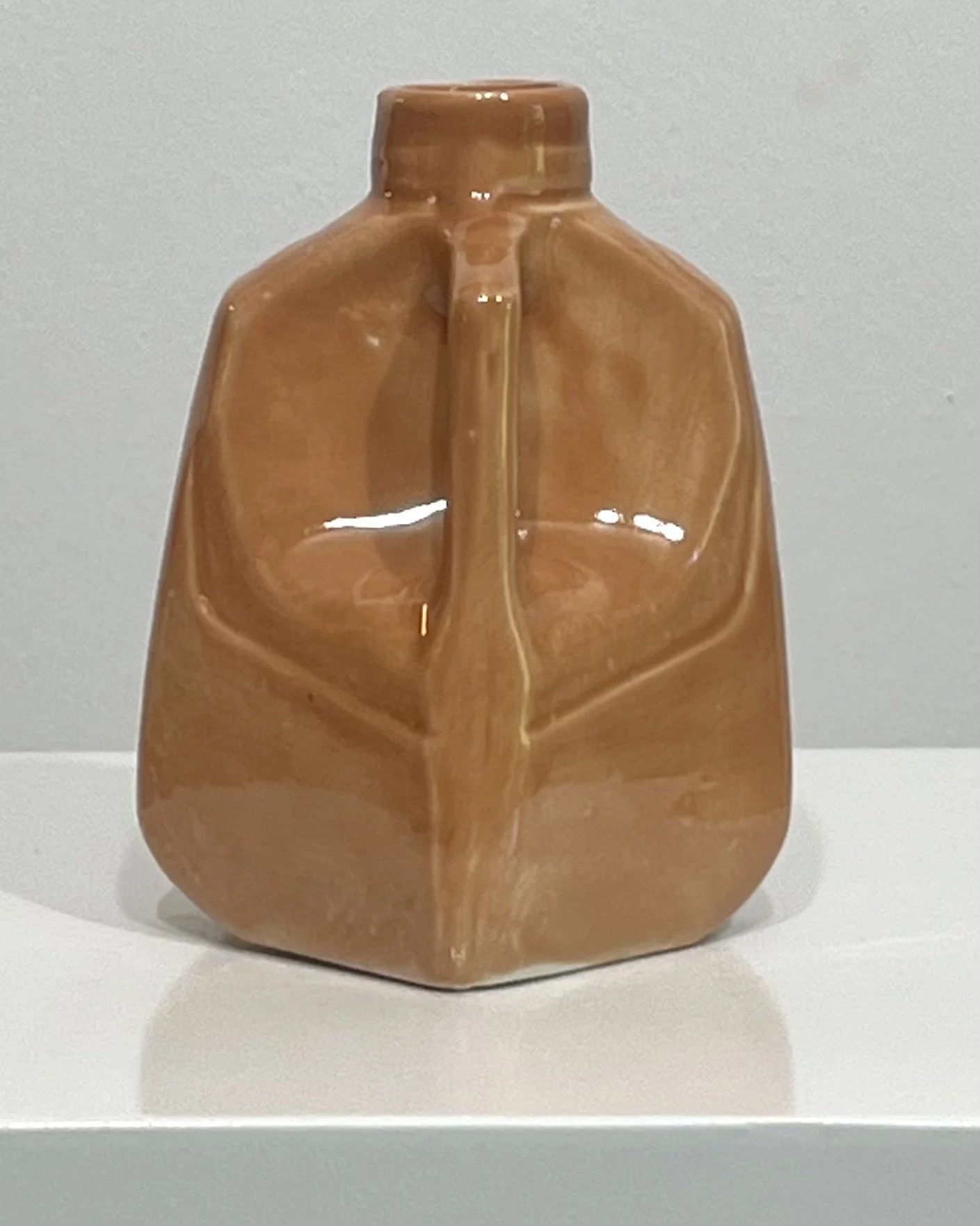Back view of a handmade porcelain milk jug vase finished in a glossy Sandalwood glaze.