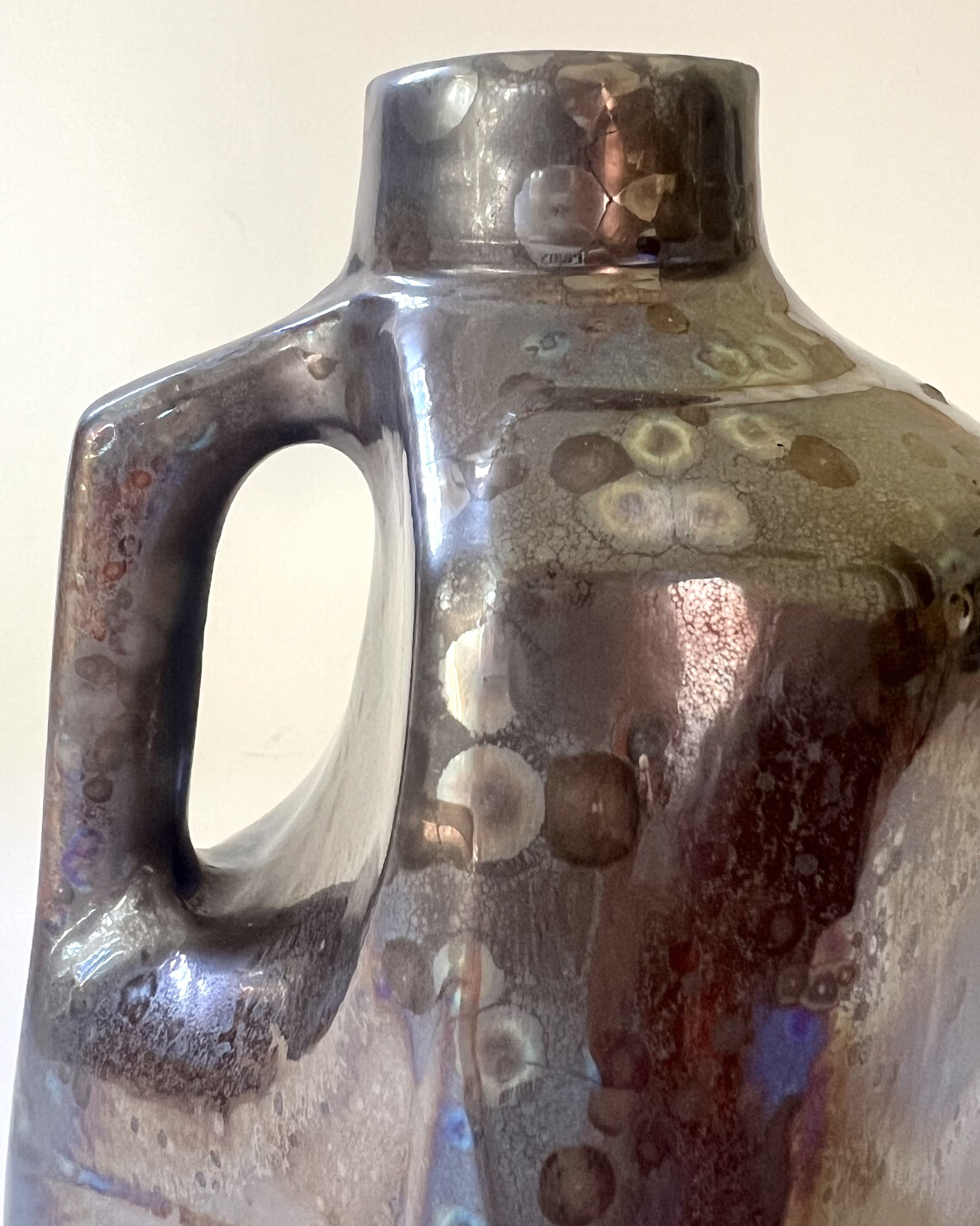 Handle detail of porcelain milk jug with Vintage Gold glaze