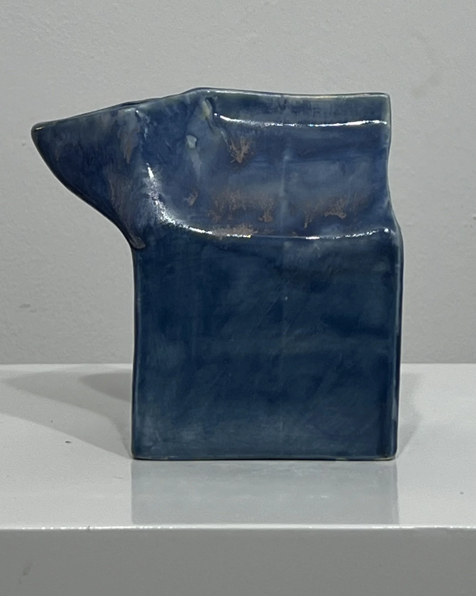 Front view of Milk Carton 26.2 Blue Splatter, a handmade porcelain vessel with layered blue glazes and flowing surface variation.