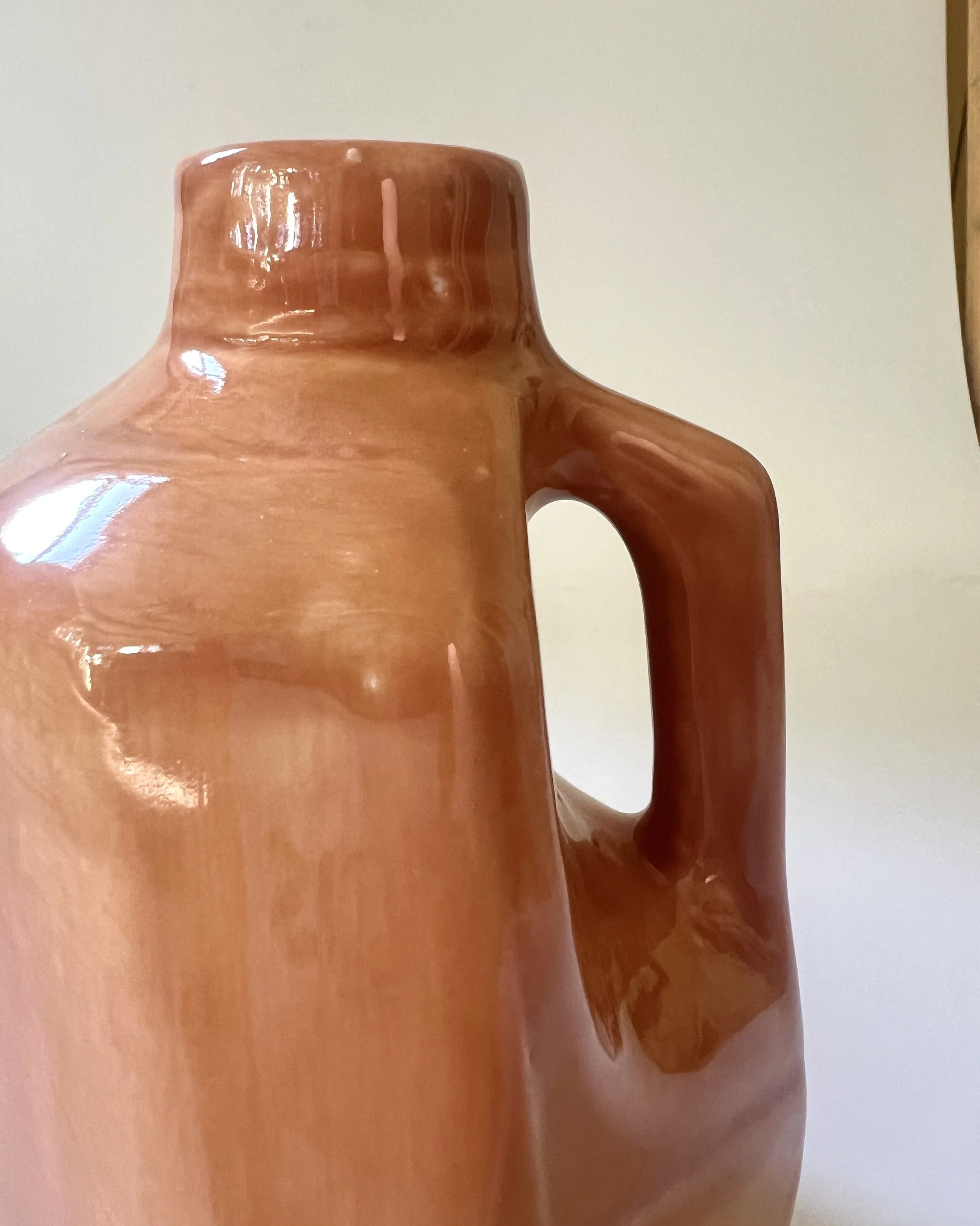 Close-up detail of Sandalwood glaze on a porcelain milk jug vase showing subtle caramel and honey-toned variations.