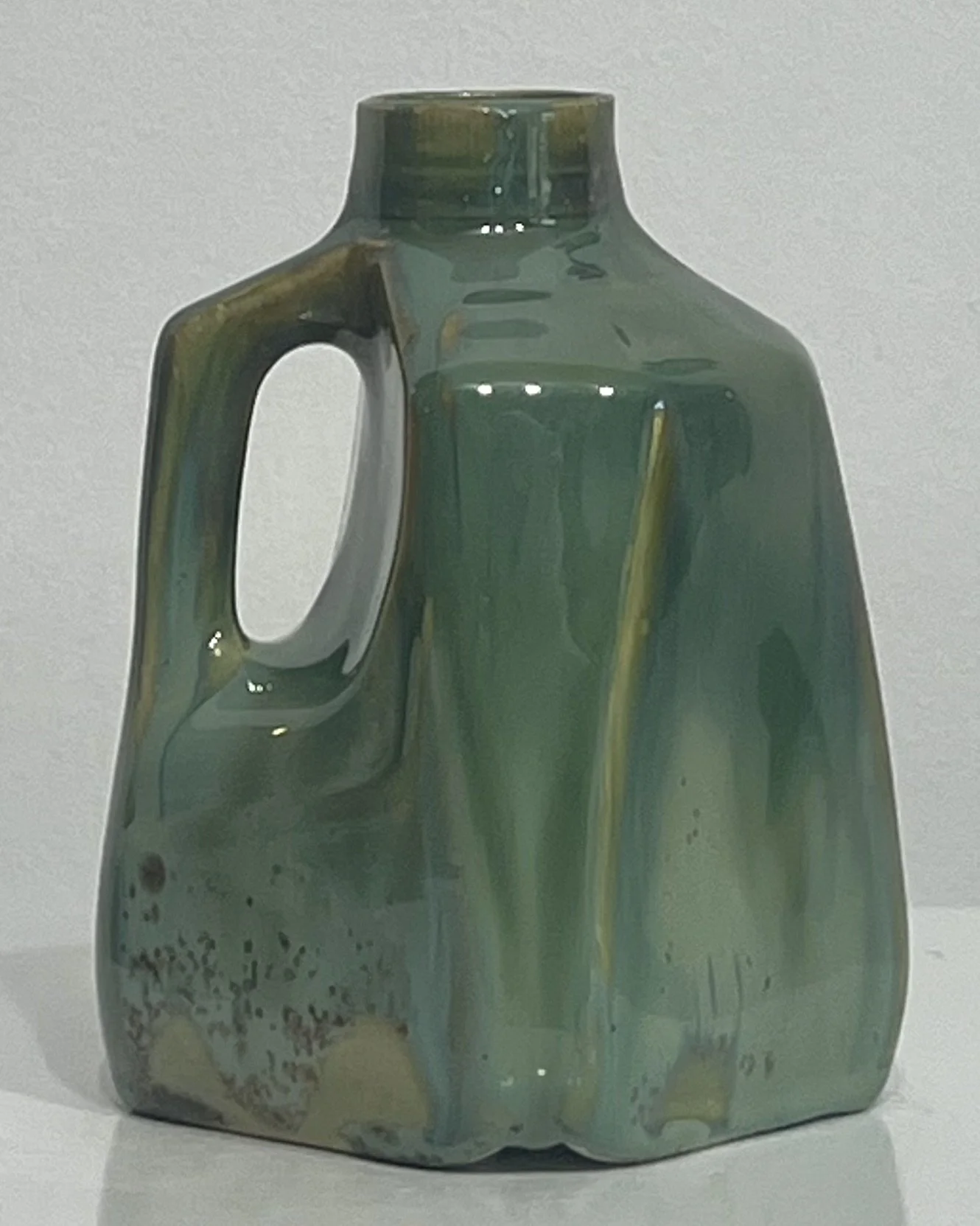 Back view of Micro Jade and Seaweed glazed porcelain milk jug showing natural glaze variations.