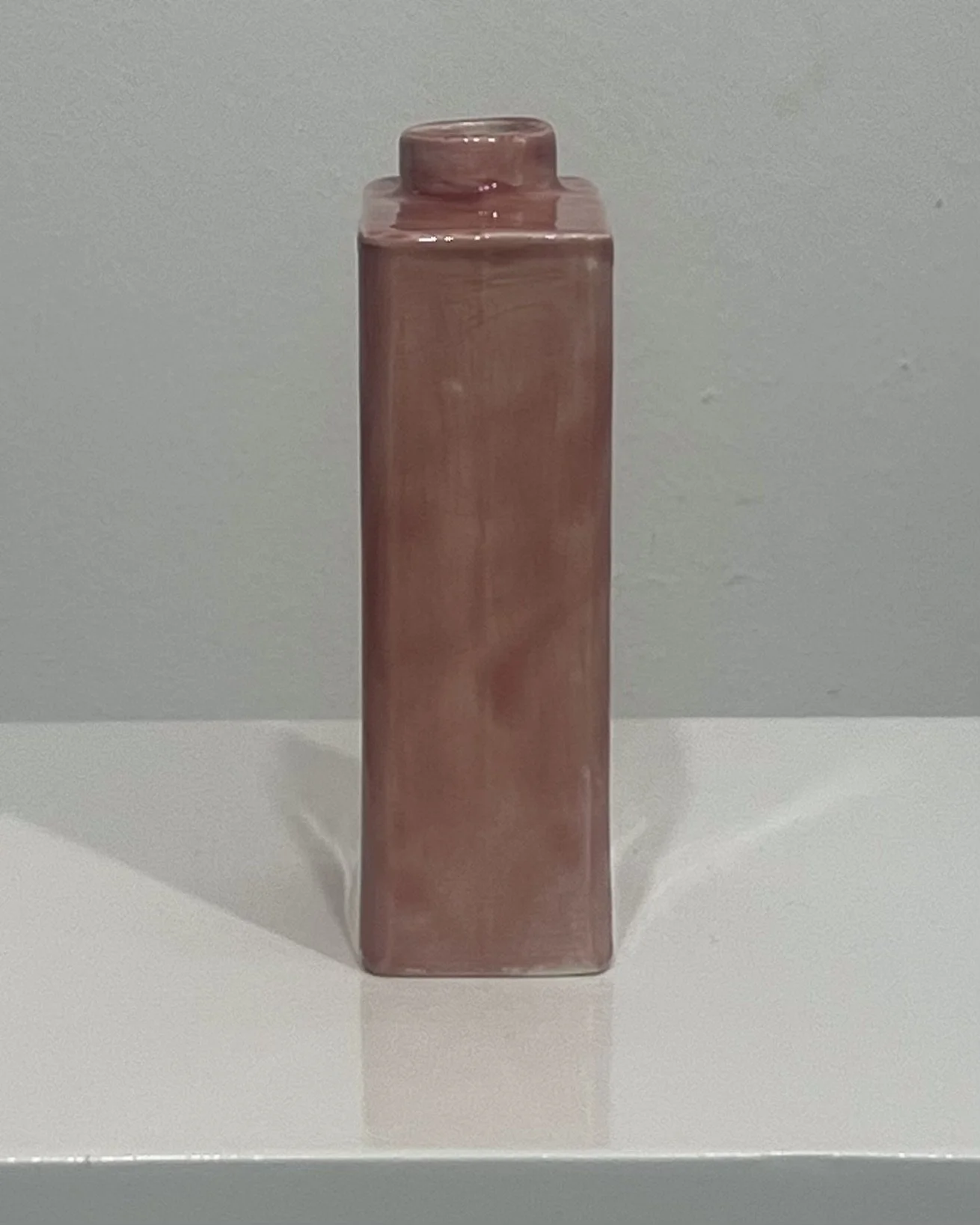 Narrow side view of porcelain carton vase showing variation in Weeping Plum glaze.