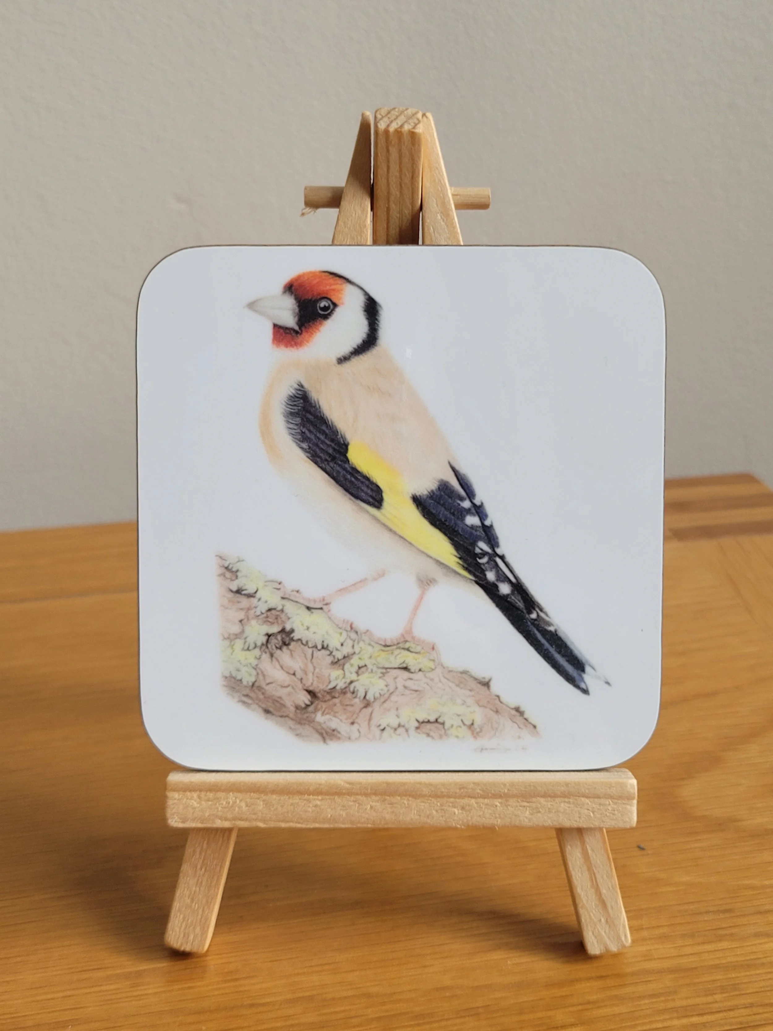 Individual glossy goldfinch coaster.