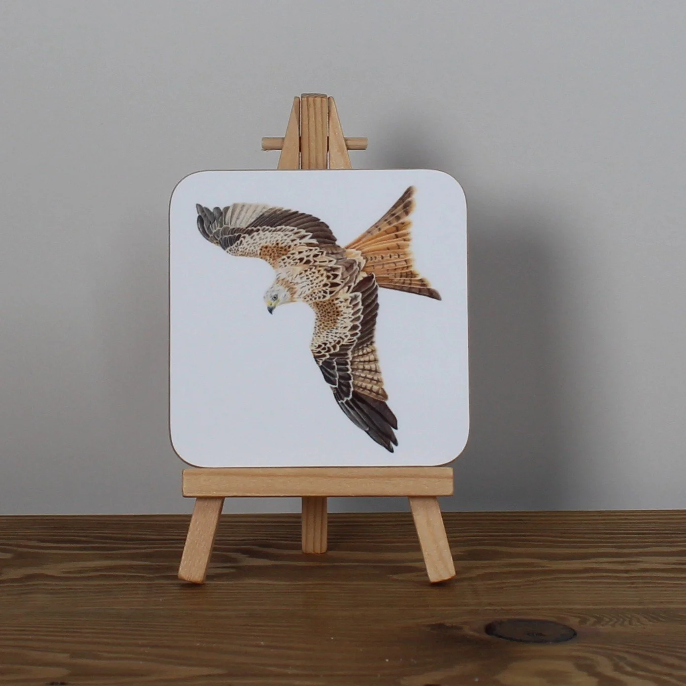 Individual glossy red kite coaster.