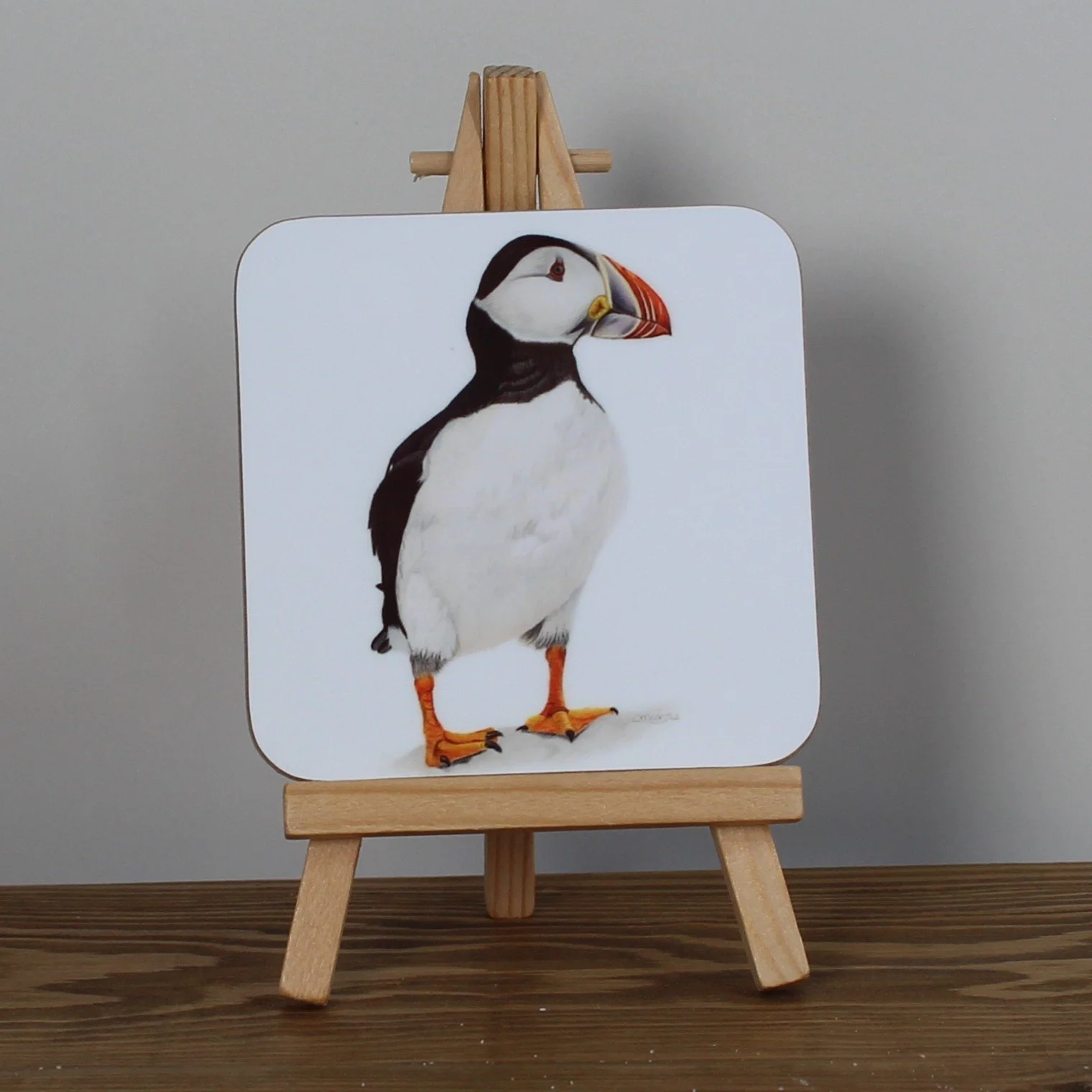 Individual glossy puffin coaster.