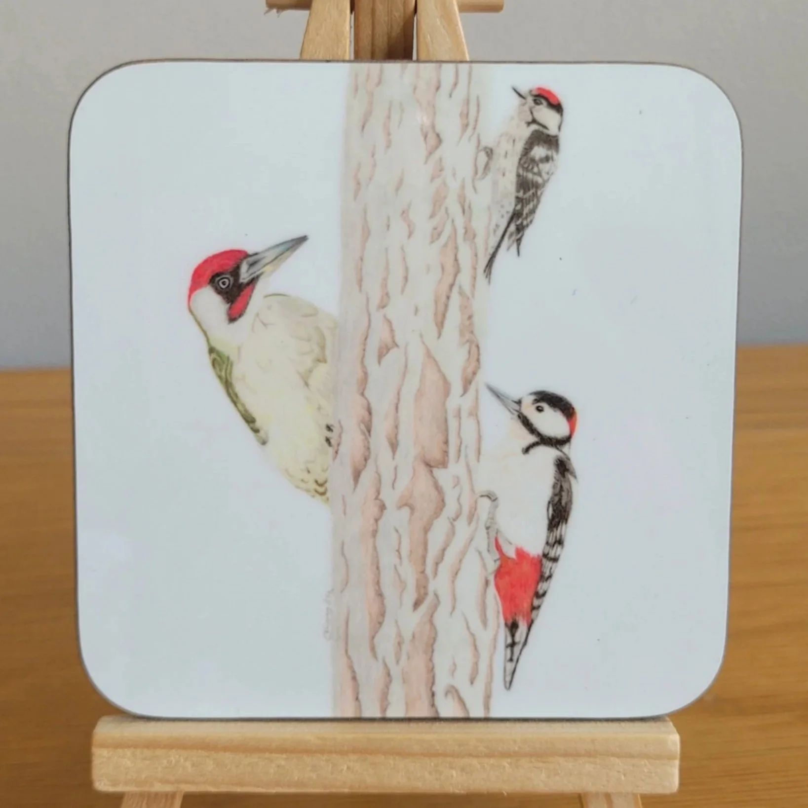 Woodpeckers coaster featuring a green woodpecker, a great spotted woodpecker and a lesser spotted woodpecker.