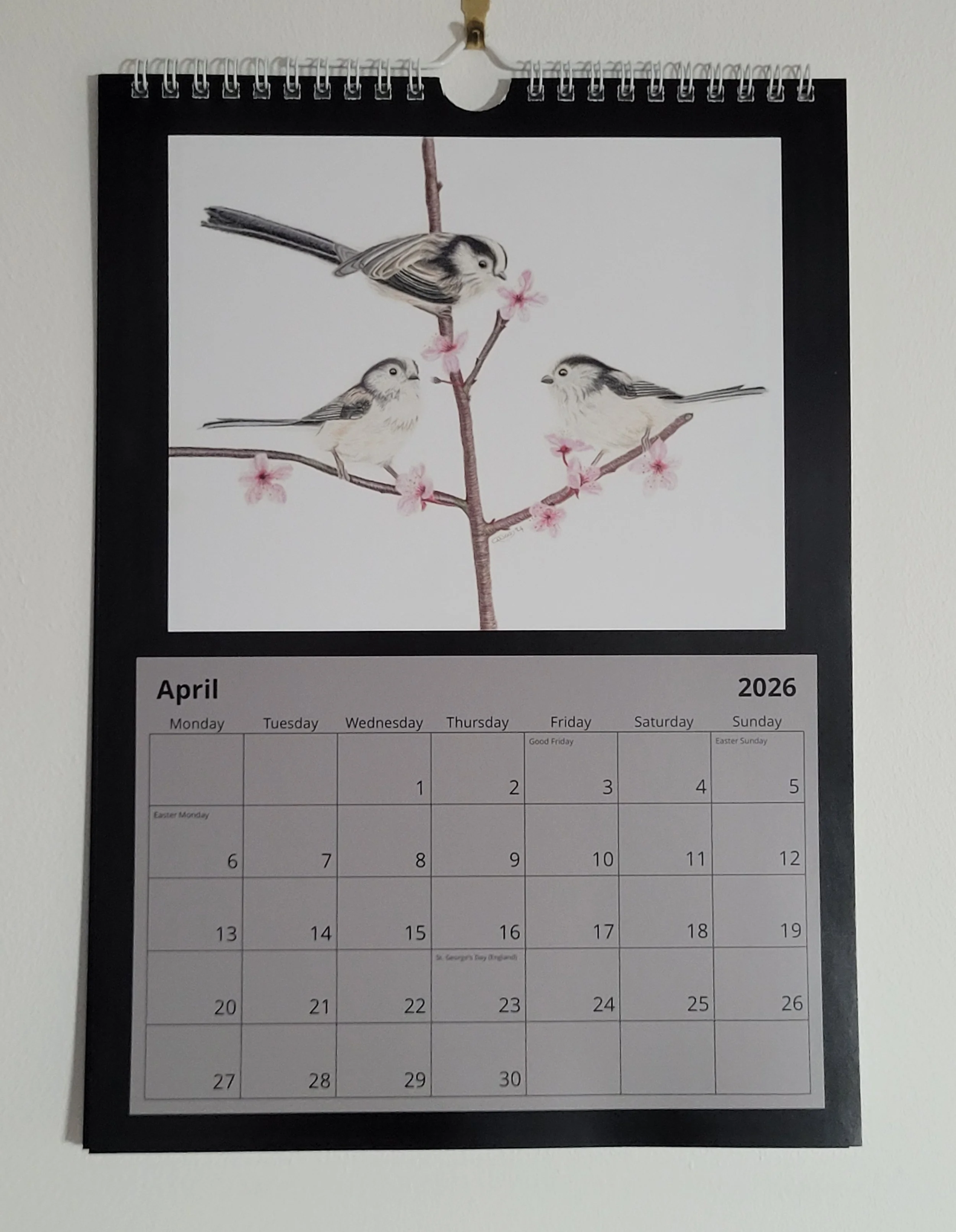 2026 wall calendar with British wildlife artwork. April features a small flock of long tailed tits.